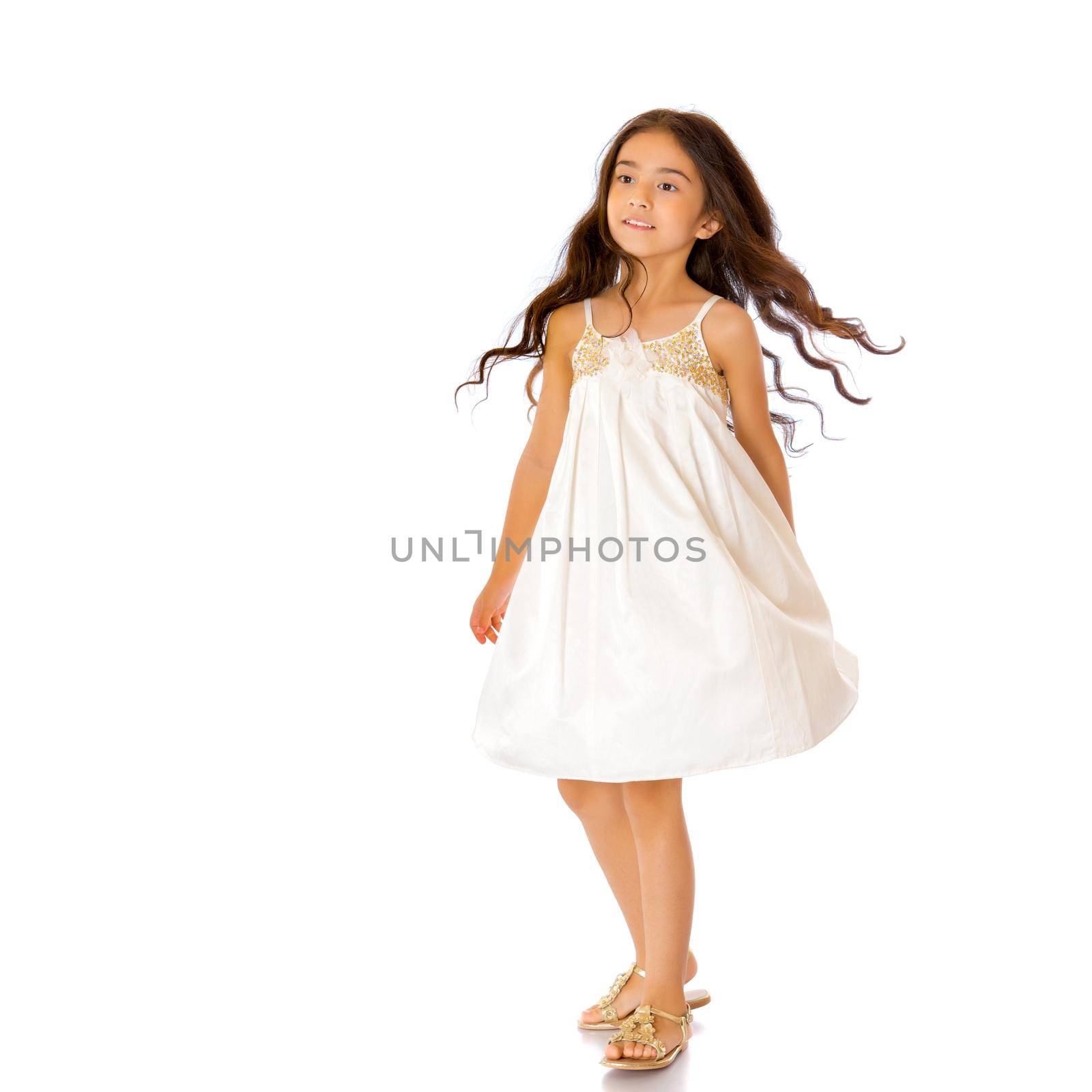 Beautiful little Asian girl in dress, full-length. The concept of style and fashion, advertising of goods. Isolated on white background.