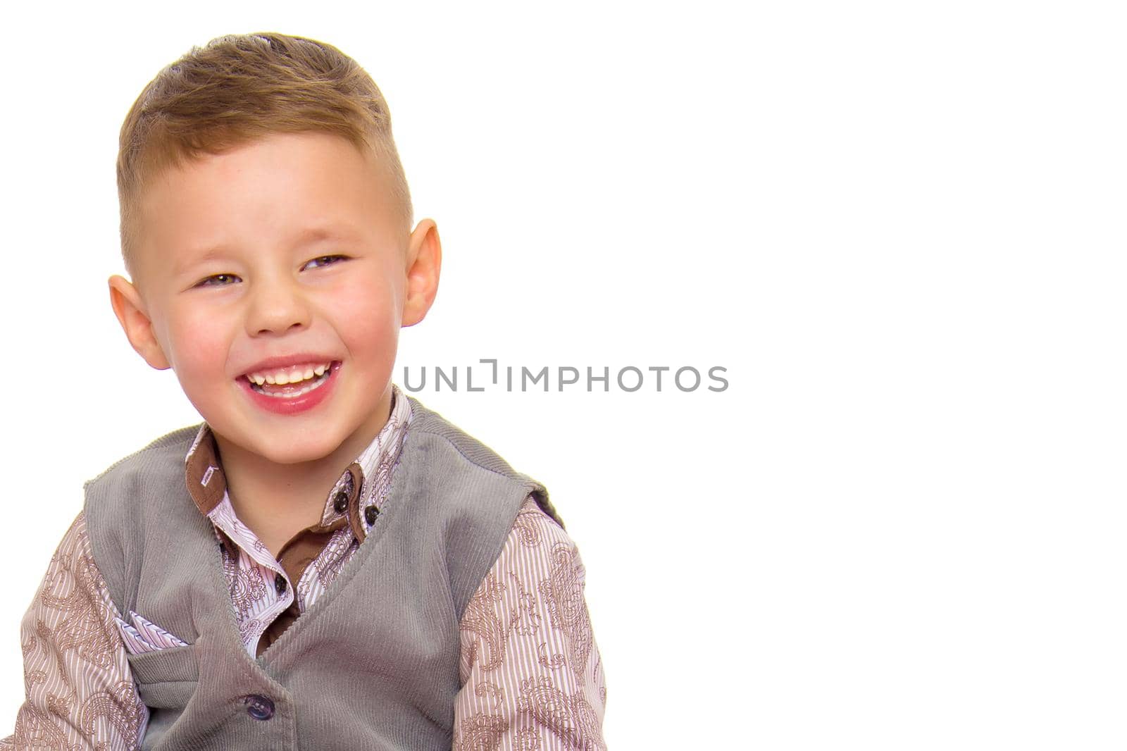 A beautiful little boy laughs fun. The concept of a happy childhood, well-being and family values. Isolated on white background.