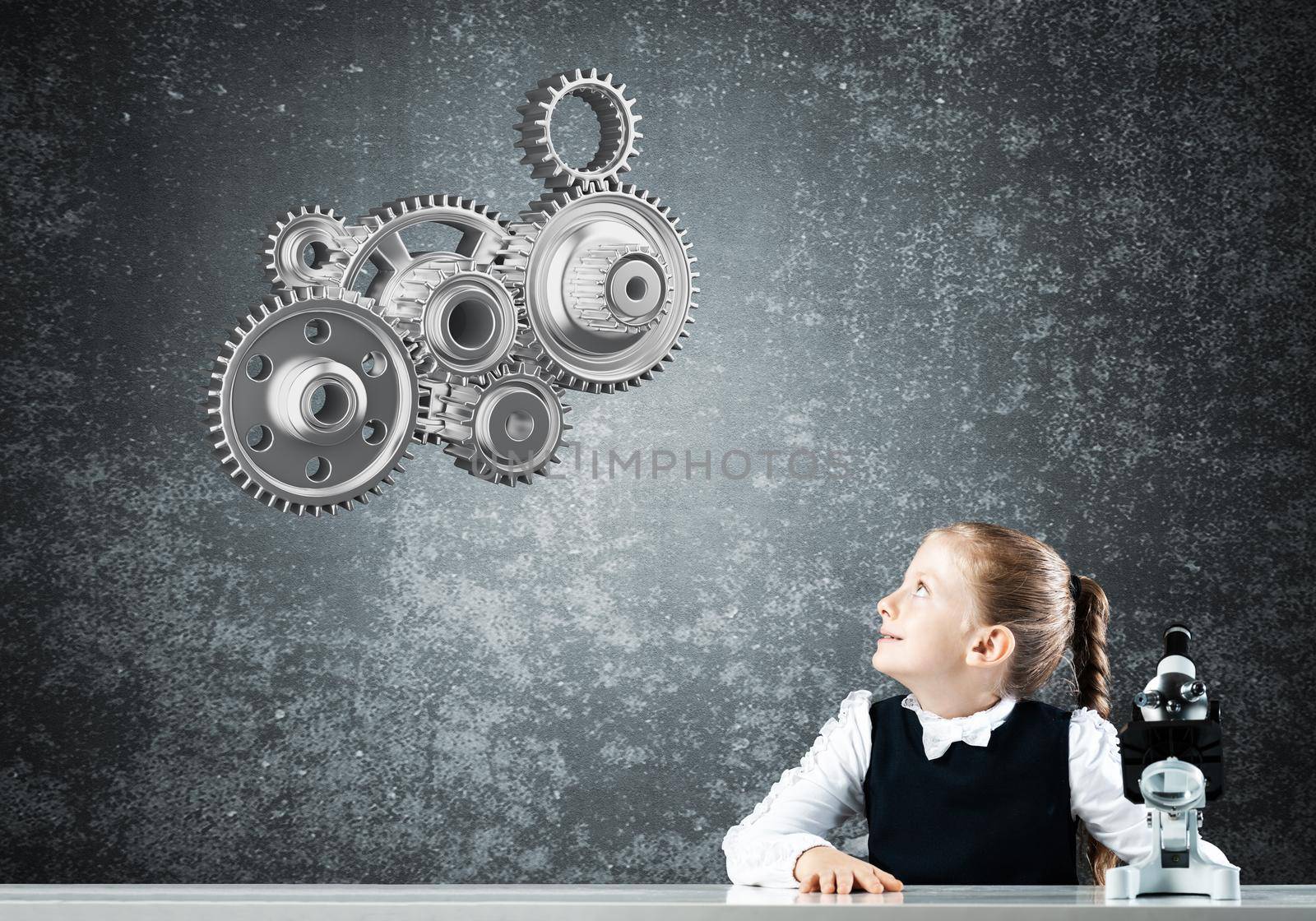 Little girl scientist with microscope on chalkboard background with gears mechanism. Research and discovery concept. Elementary science class in modern school. Schoolgirl in schoolwear sitting at desk