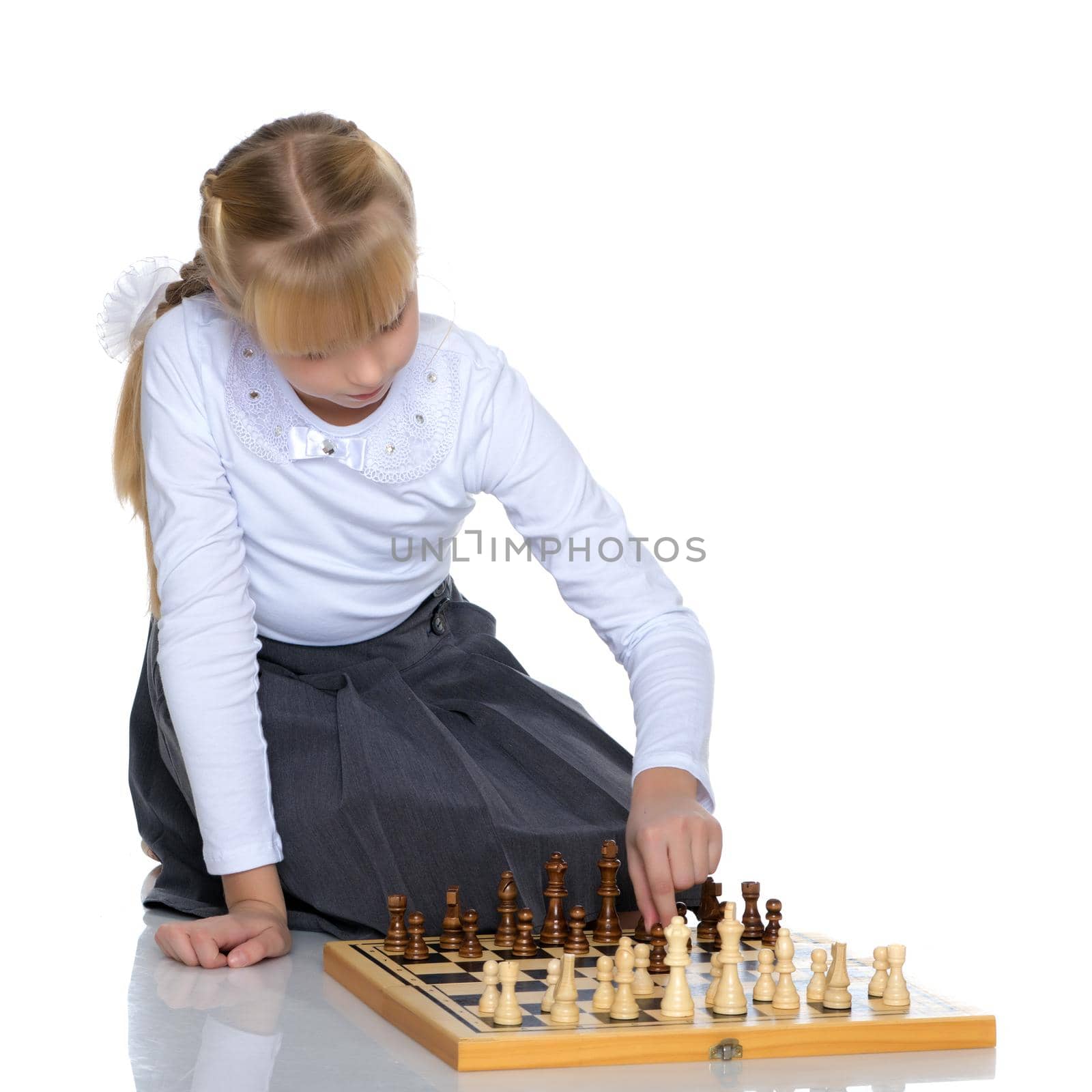 Little girl playing chess by kolesnikov_studio