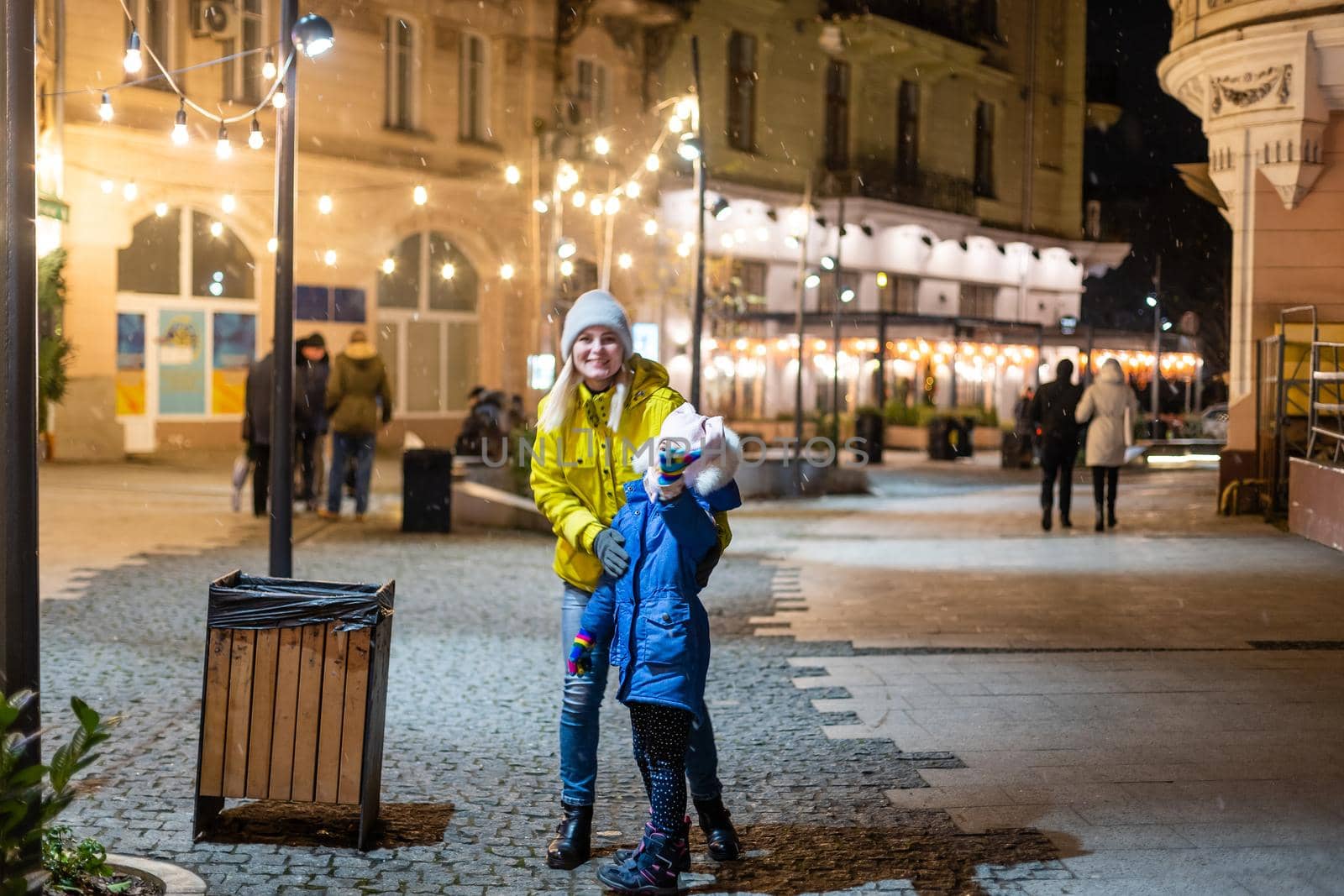 Mother and daughter are walking around the city on Christmas and New Year holidays.