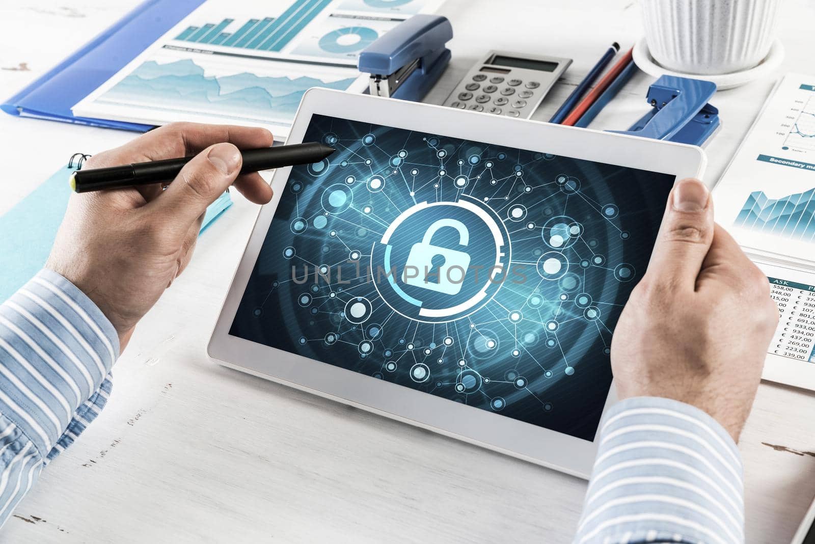 close-up, male hands with tablet. Businessman working at the table in office. computer security concept