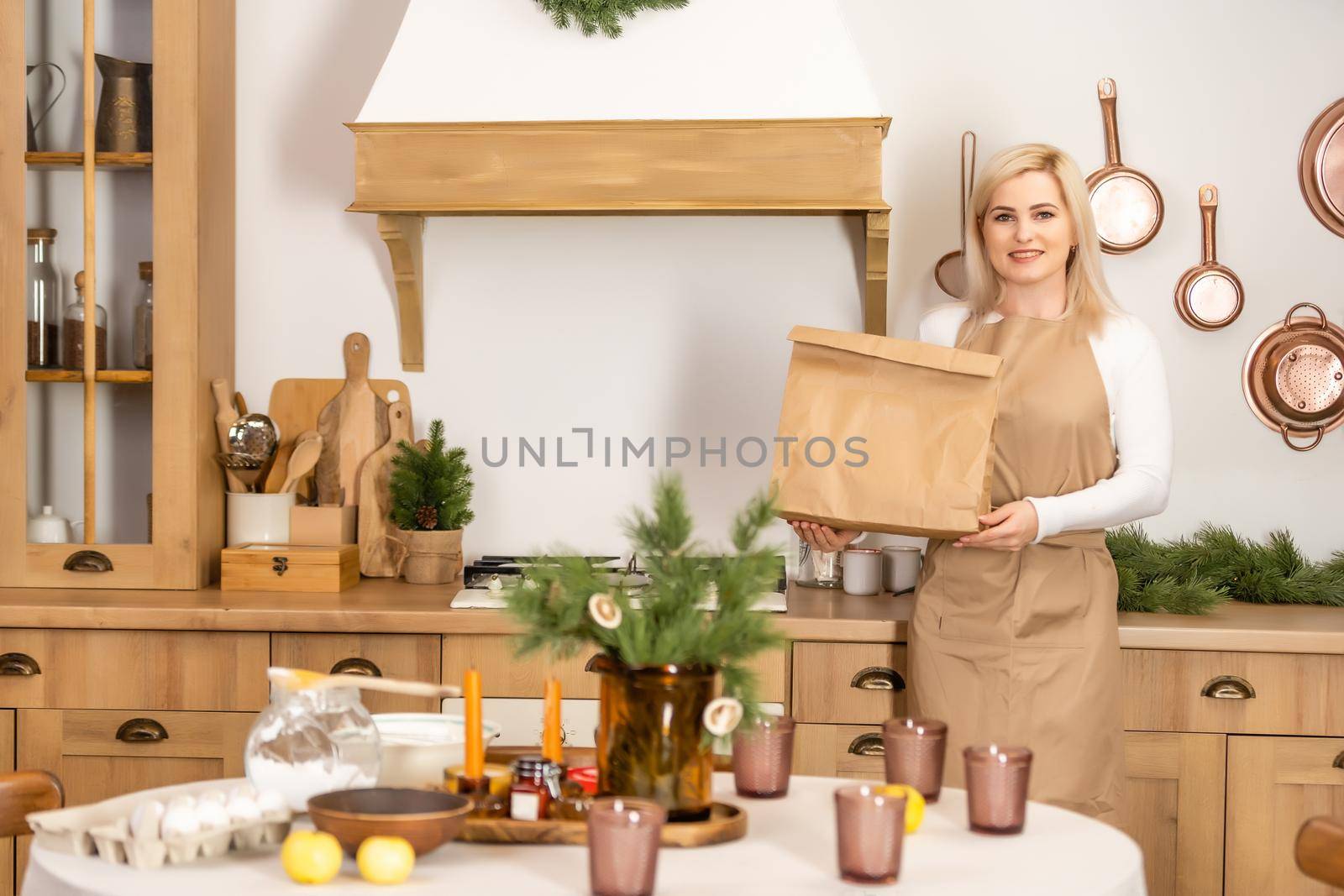 Young beautiful woman holding take away paper bag from delivery