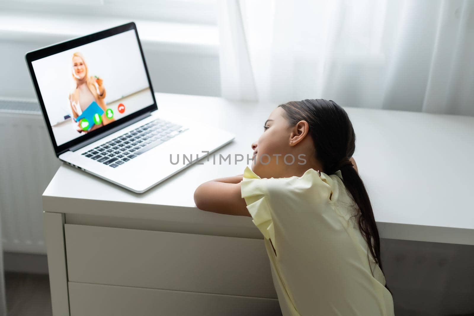 home, leisure, technology and internet concept - little student girl with laptop computer at home, little girl uses video chat by Andelov13