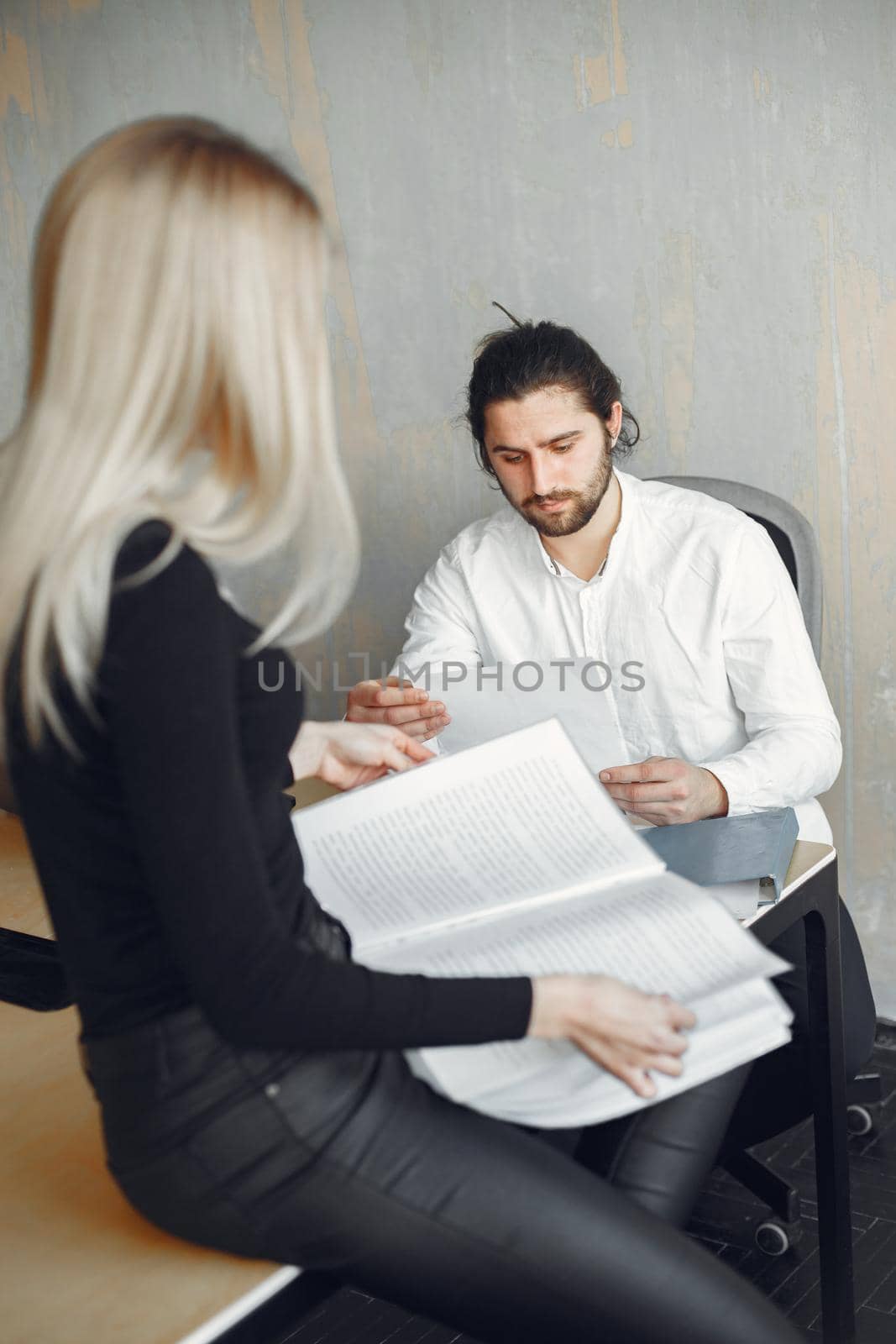 Handsome man in a white shirt. Partners together. Guy with a laptop.