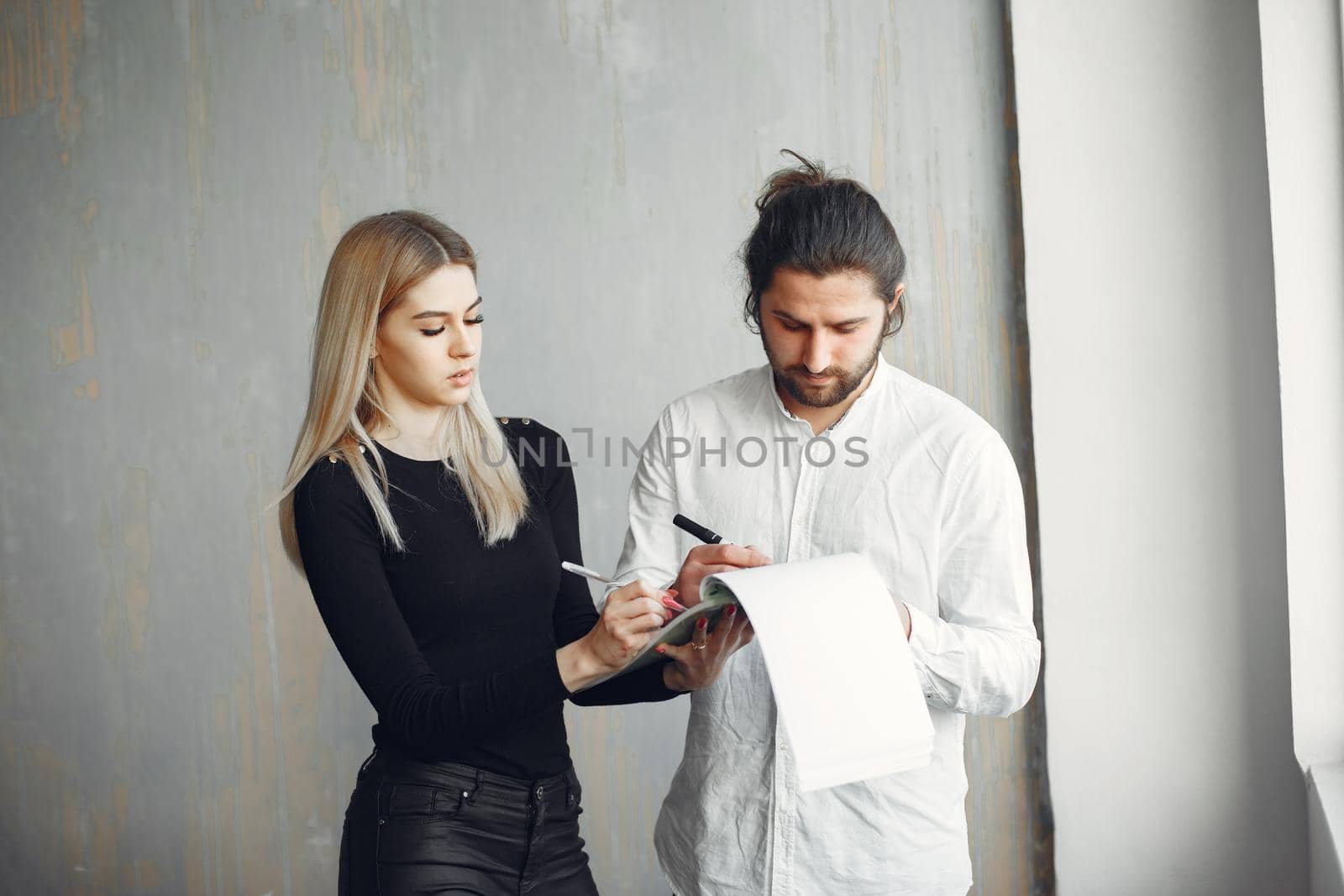 Handsome man in a white shirt. Partners together. People by the window.