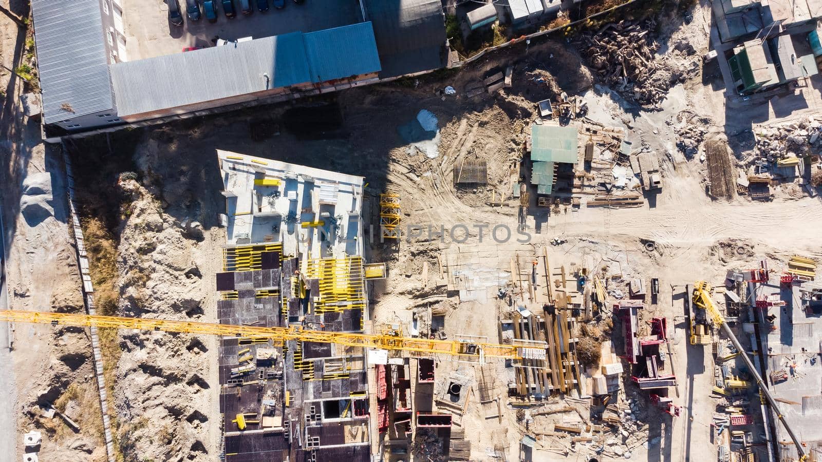 Construction site background. Hoisting cranes and new multi-storey buildings. Industrial background.