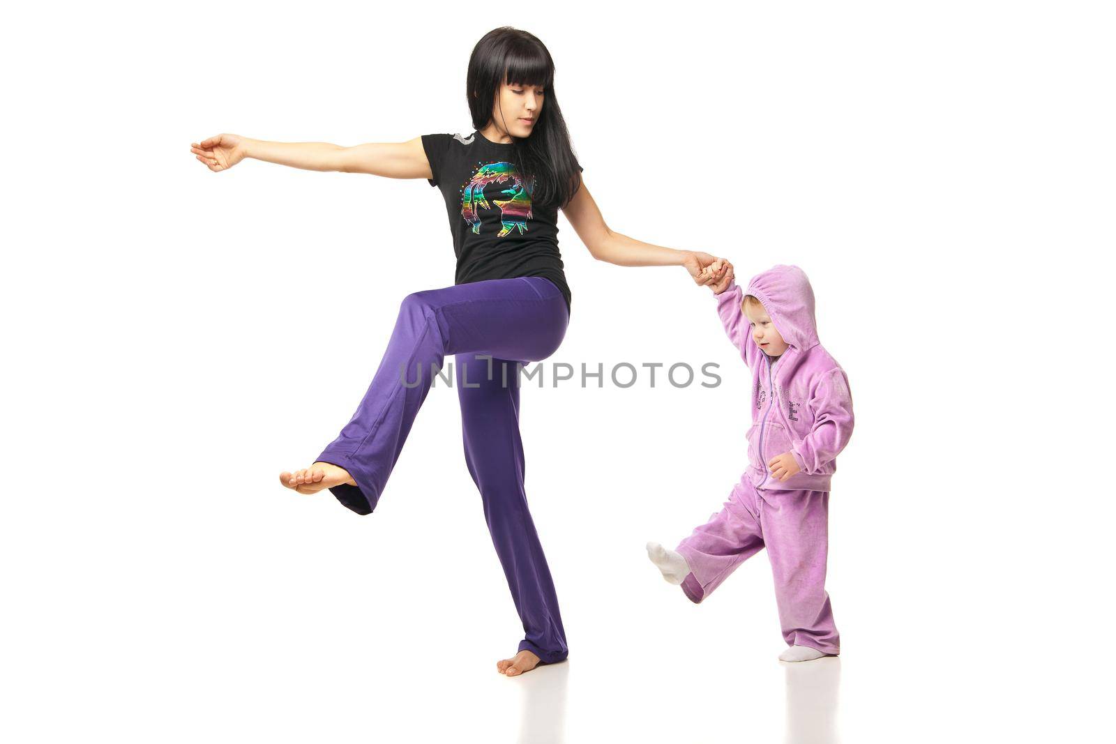 Yoga for woman and child. Mother with the baby doing exercises