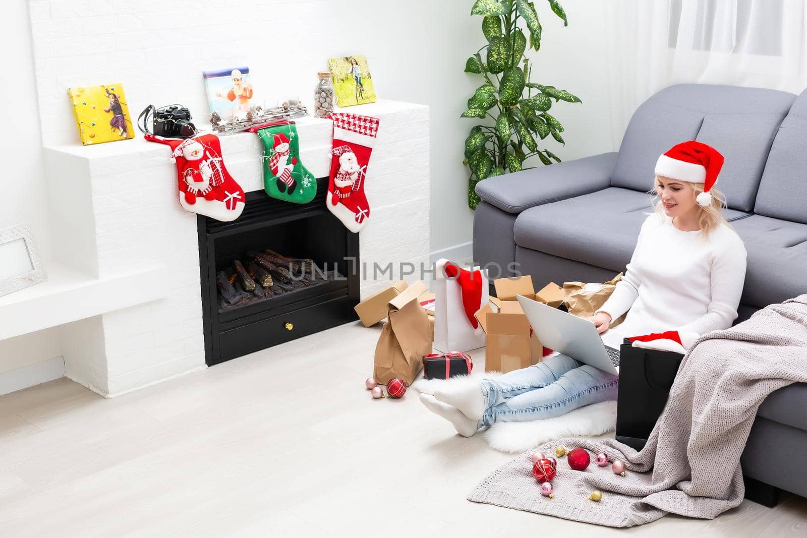 Young woman ordering Christmas gifts online Christmastime decorations by Andelov13