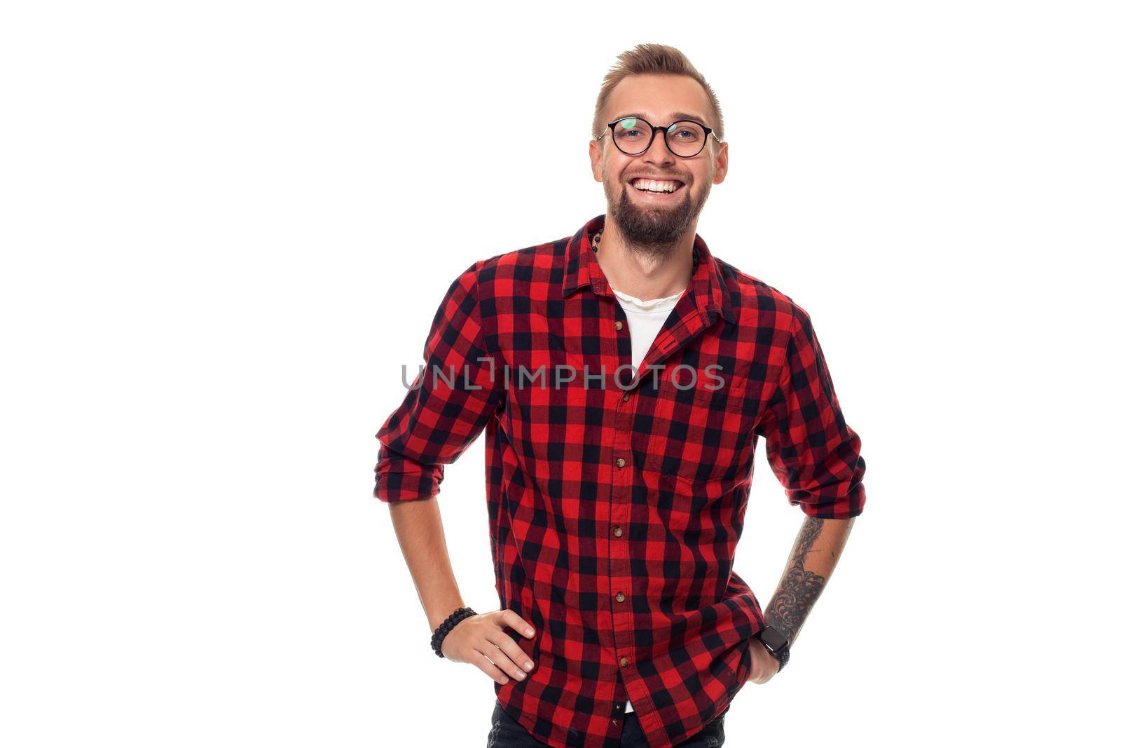 Handsome man model studio portrait. Boy casual style, trendy hipster in checkered shirt look with cool hairstyle. Studio shot on white background. Copy space