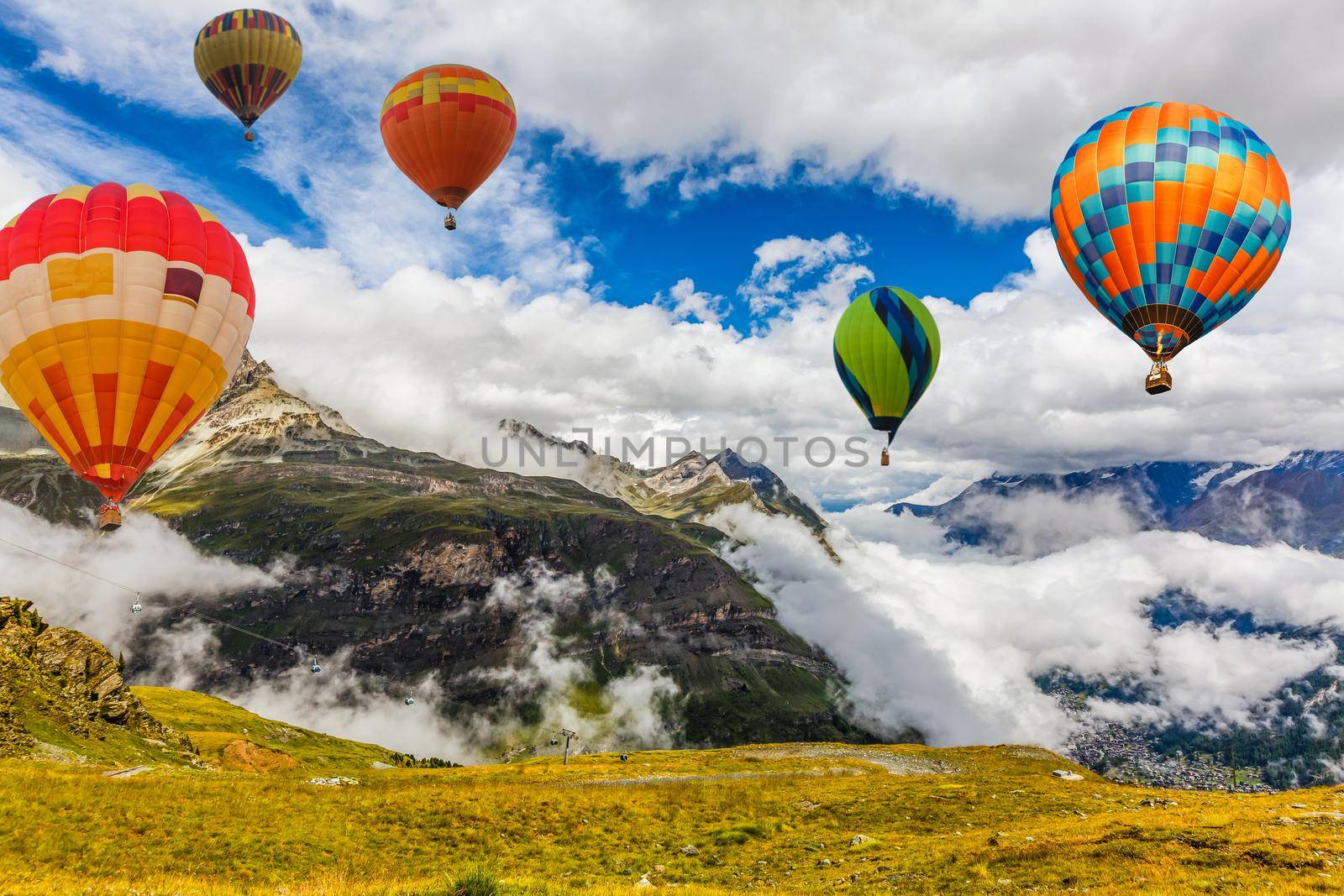 Sunset over forest mountain with hot air balloon.