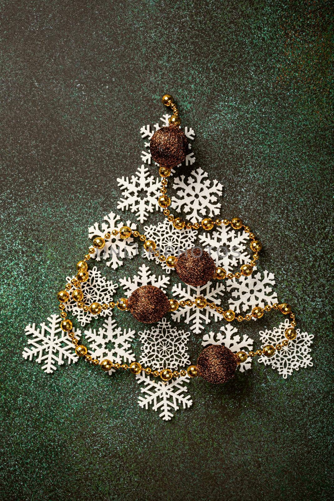 Overhead shoot of wooden christmas tree and decoration. Winter holidays background with copy space, flat lay, top view.