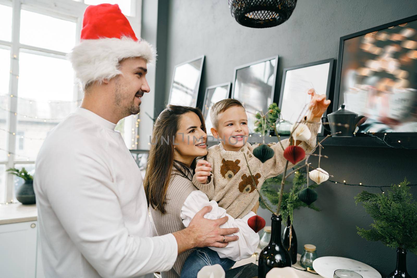 Happy family making Christmas decorations at home together, portrait