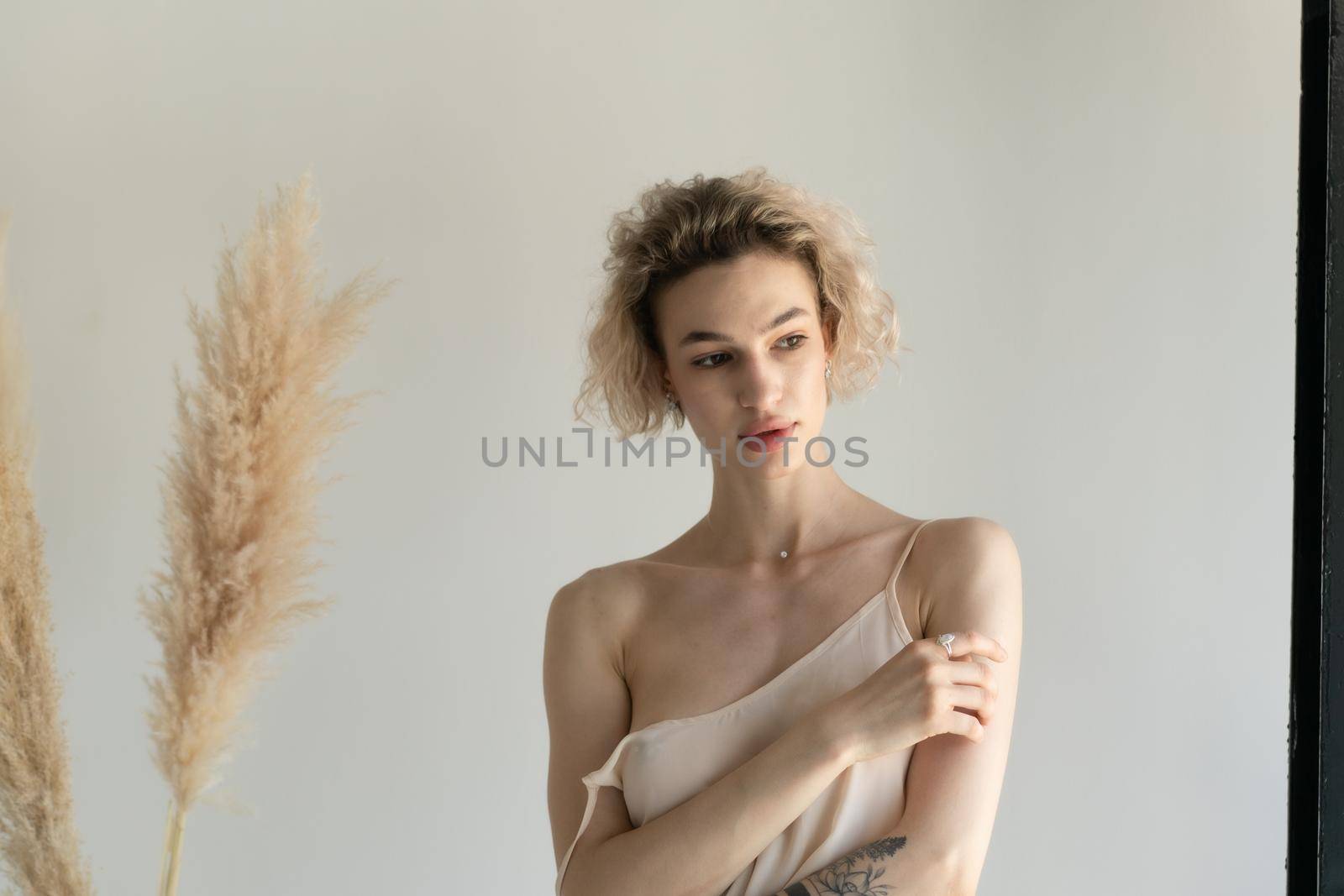 young beautiful woman posing in white lingerie in studio