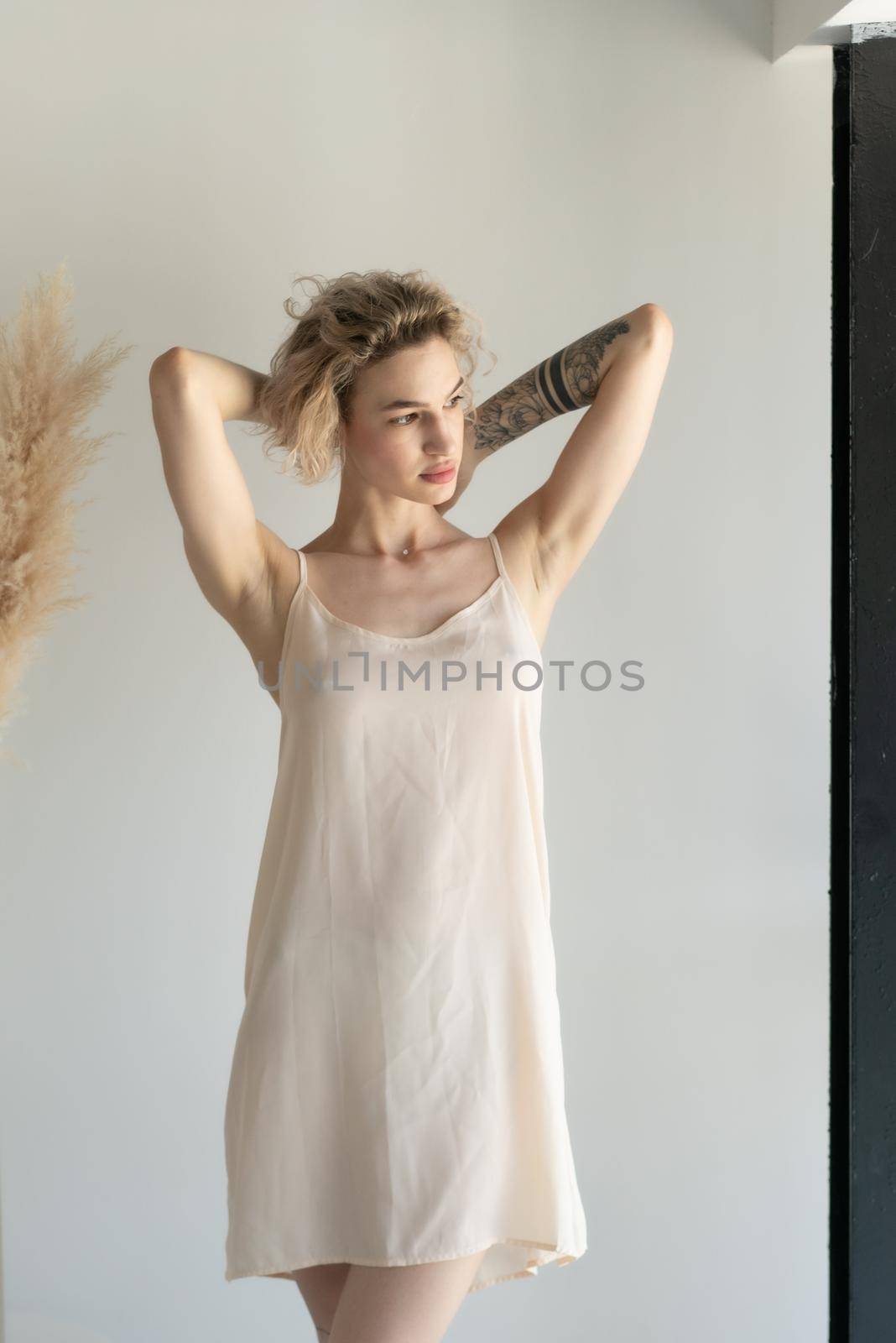 young beautiful woman posing in white lingerie in studio by Igorsmirnof