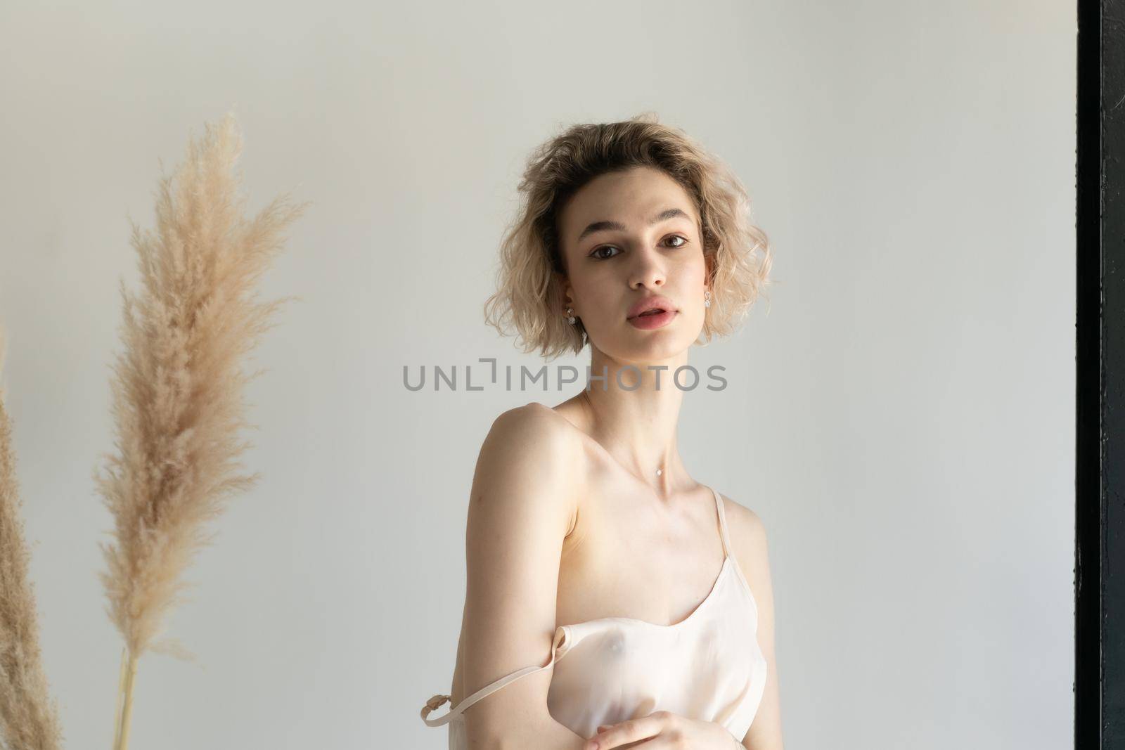 young beautiful woman posing in white lingerie in studio