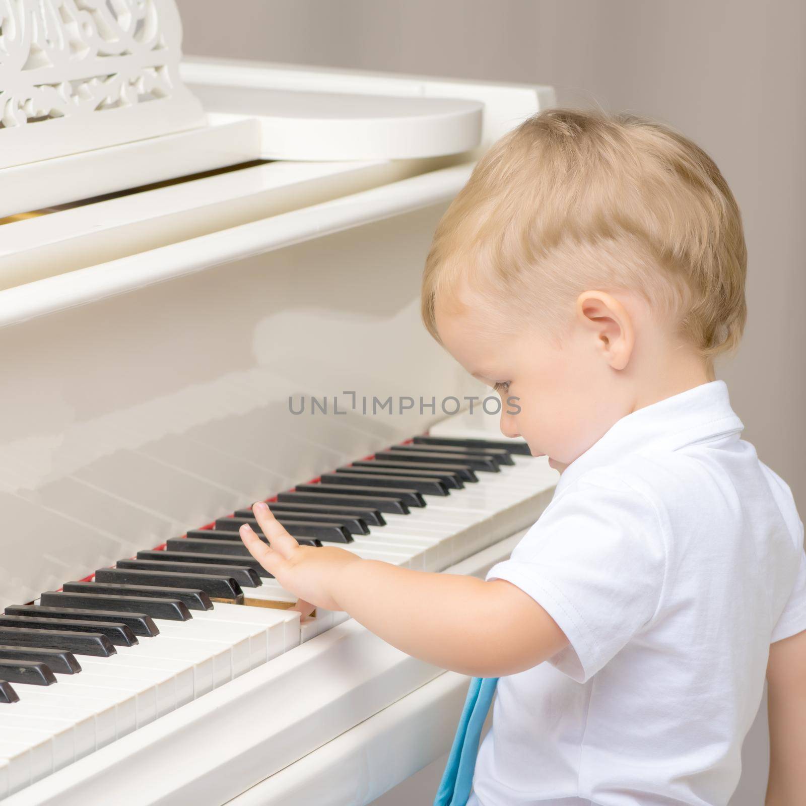 Little boy playing piano at home. Concept of music