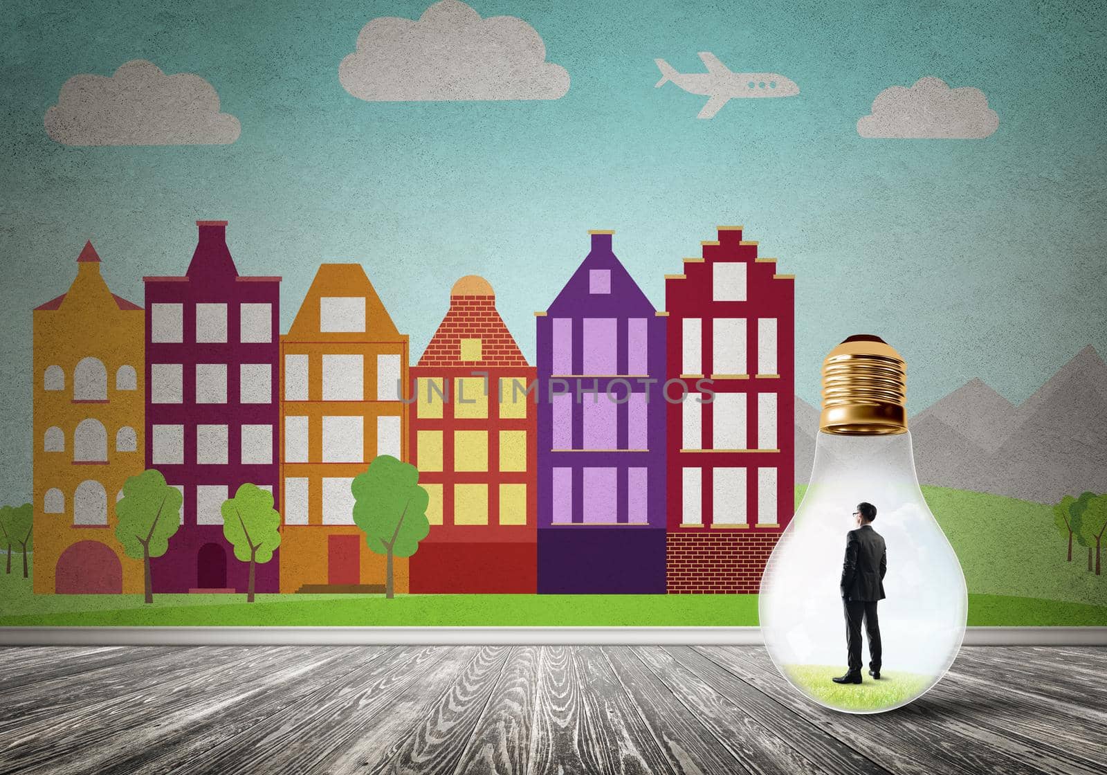 Businessman inside light bulb against city drawn concept