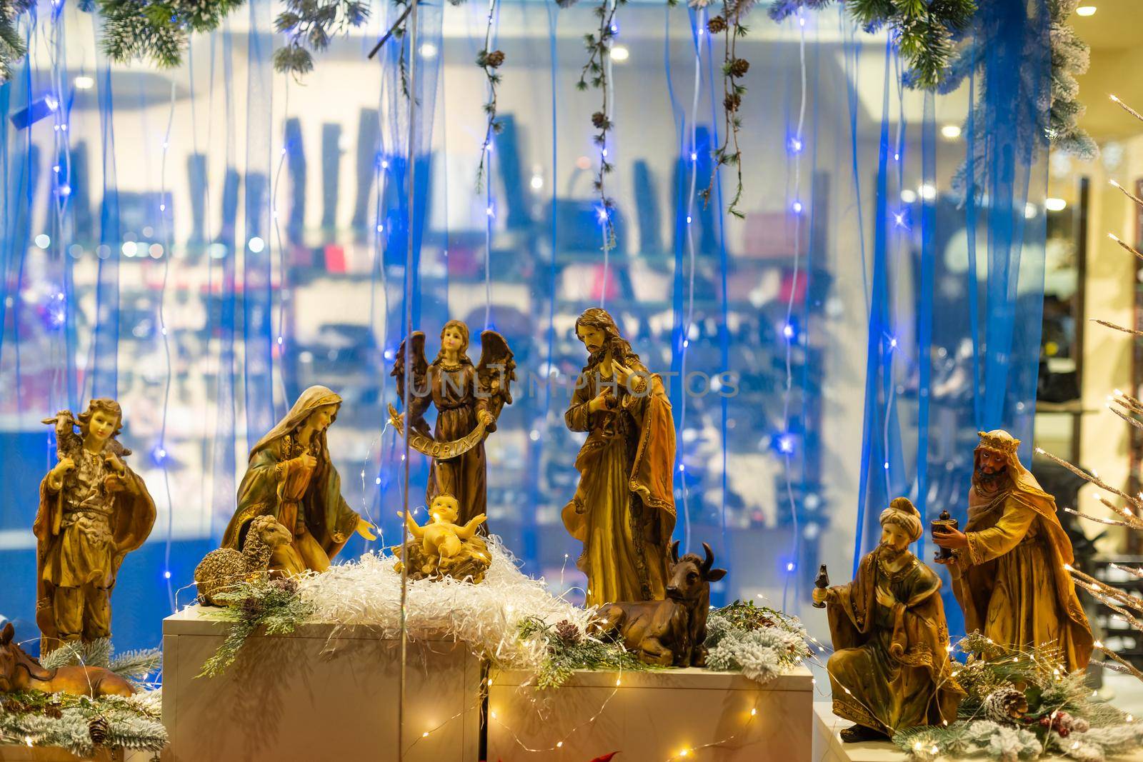 Christmas nativity scene photograph of Mary, a king, a shepherd and lamb worshipping baby Jesus.