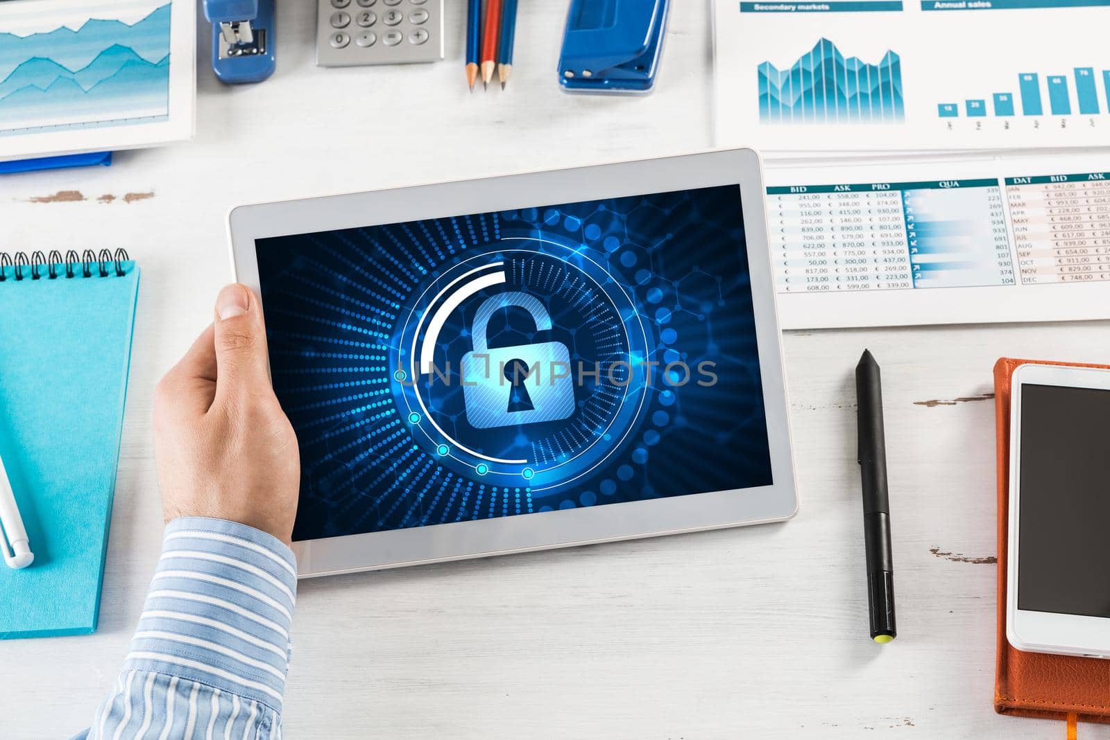 close-up, male hands with tablet. Businessman working at the table in office. computer security concept