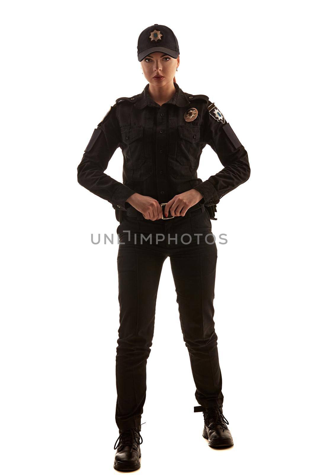 Full length shot of a redheaded female police officer posing for the camera isolated on white background. by nazarovsergey