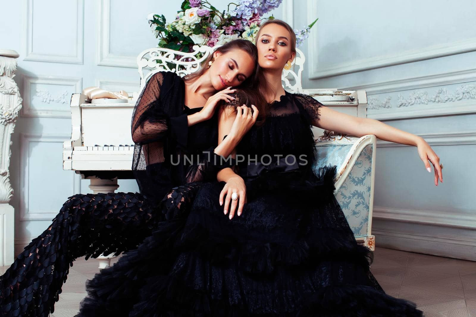 two young pretty lady in black lace fashion style dress posing in rich interior of royal hotel room, luxury lifestyle people concept closeup