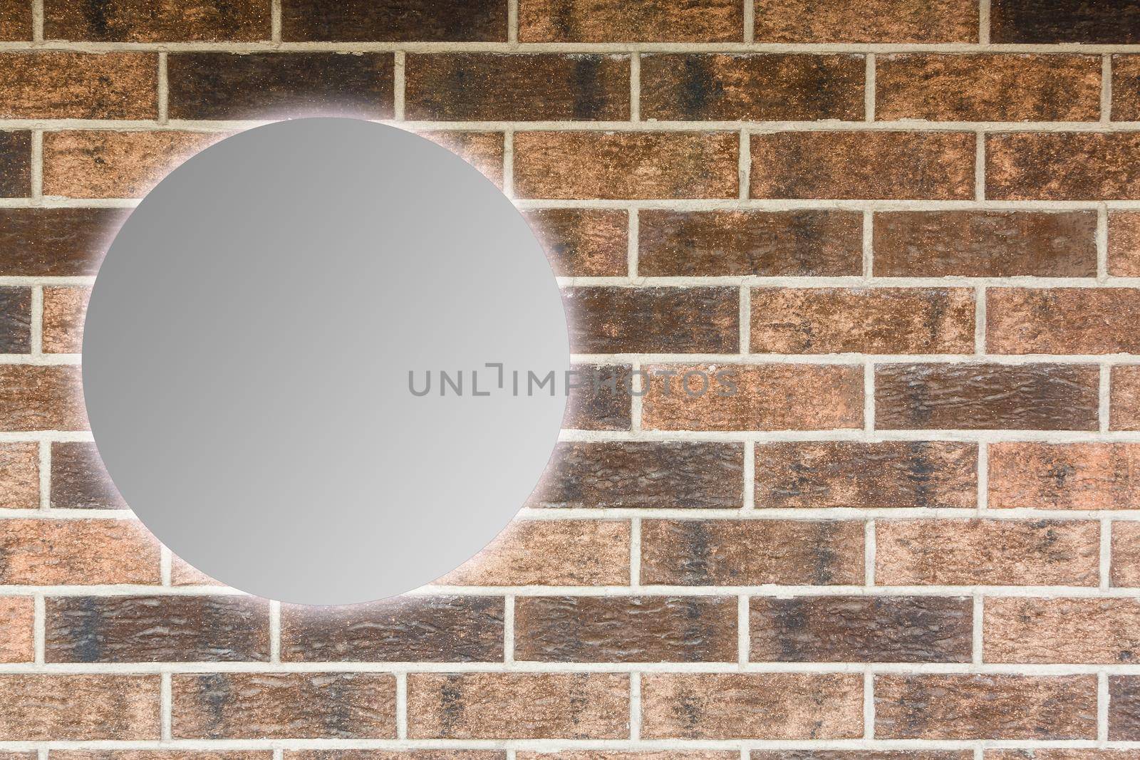Round mirror near brick wall