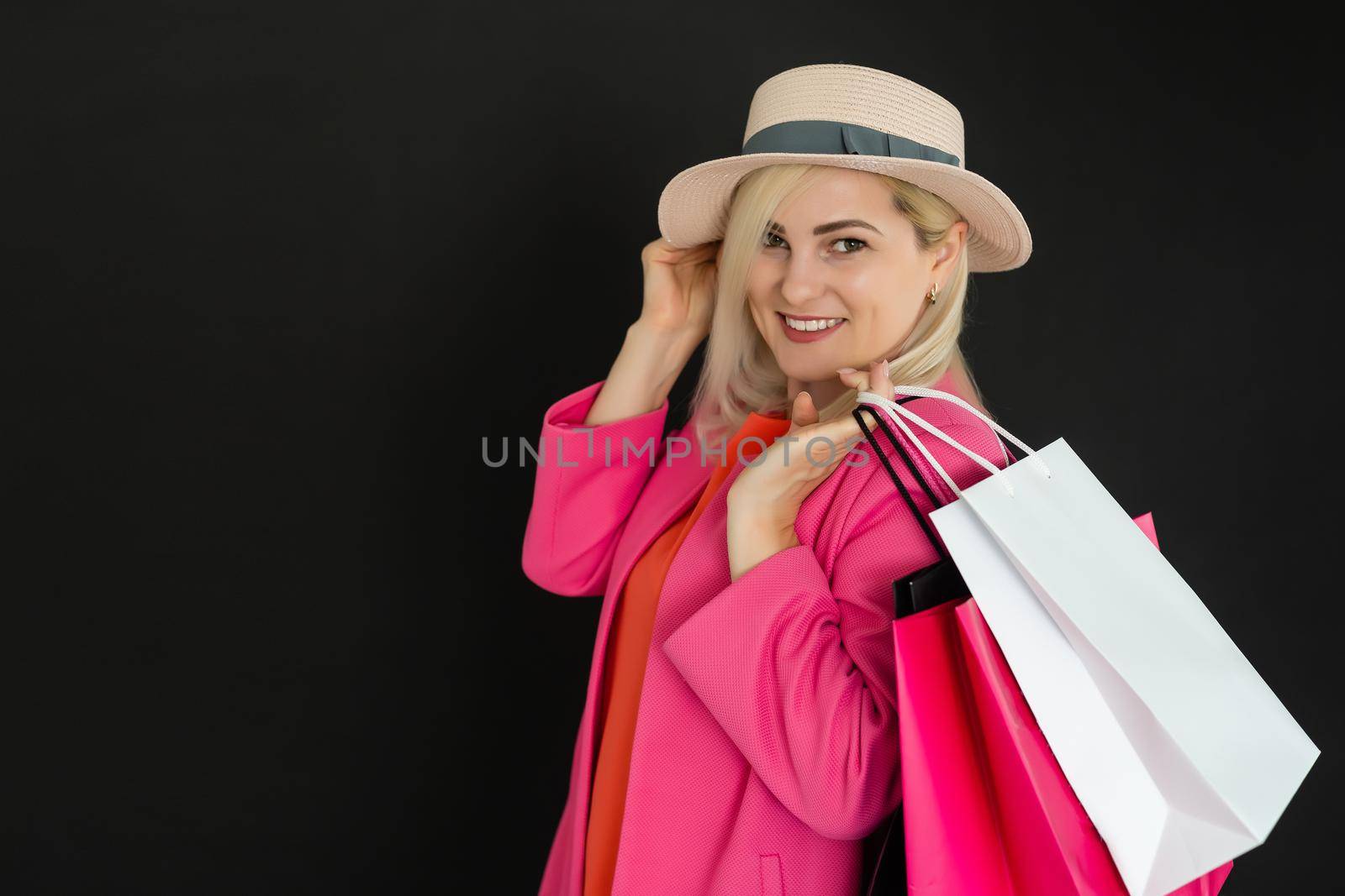 Elegant woman holding black shopping bags, black friday concept