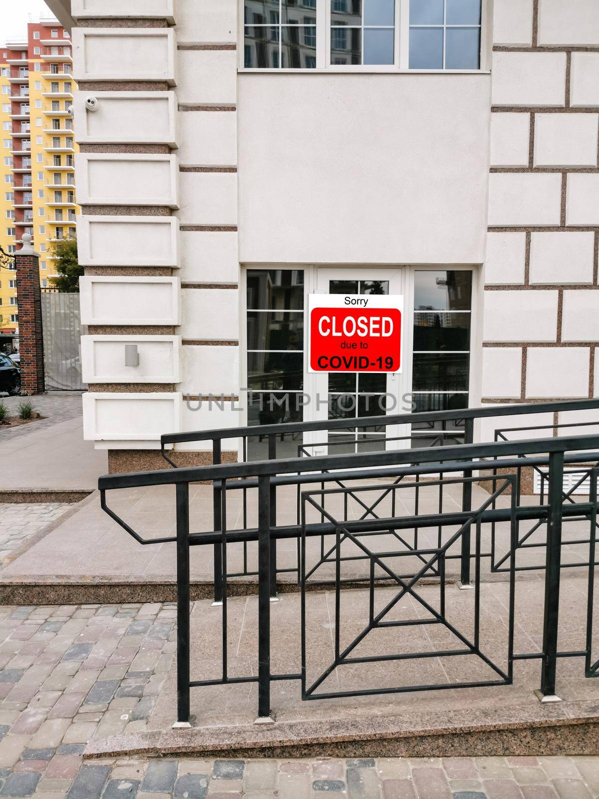 Business center closed due to COVID-19, sign with sorry in door window. Stores, restaurants, offices, other public places temporarily closed during coronavirus pandemic. Economy hit by corona virus.