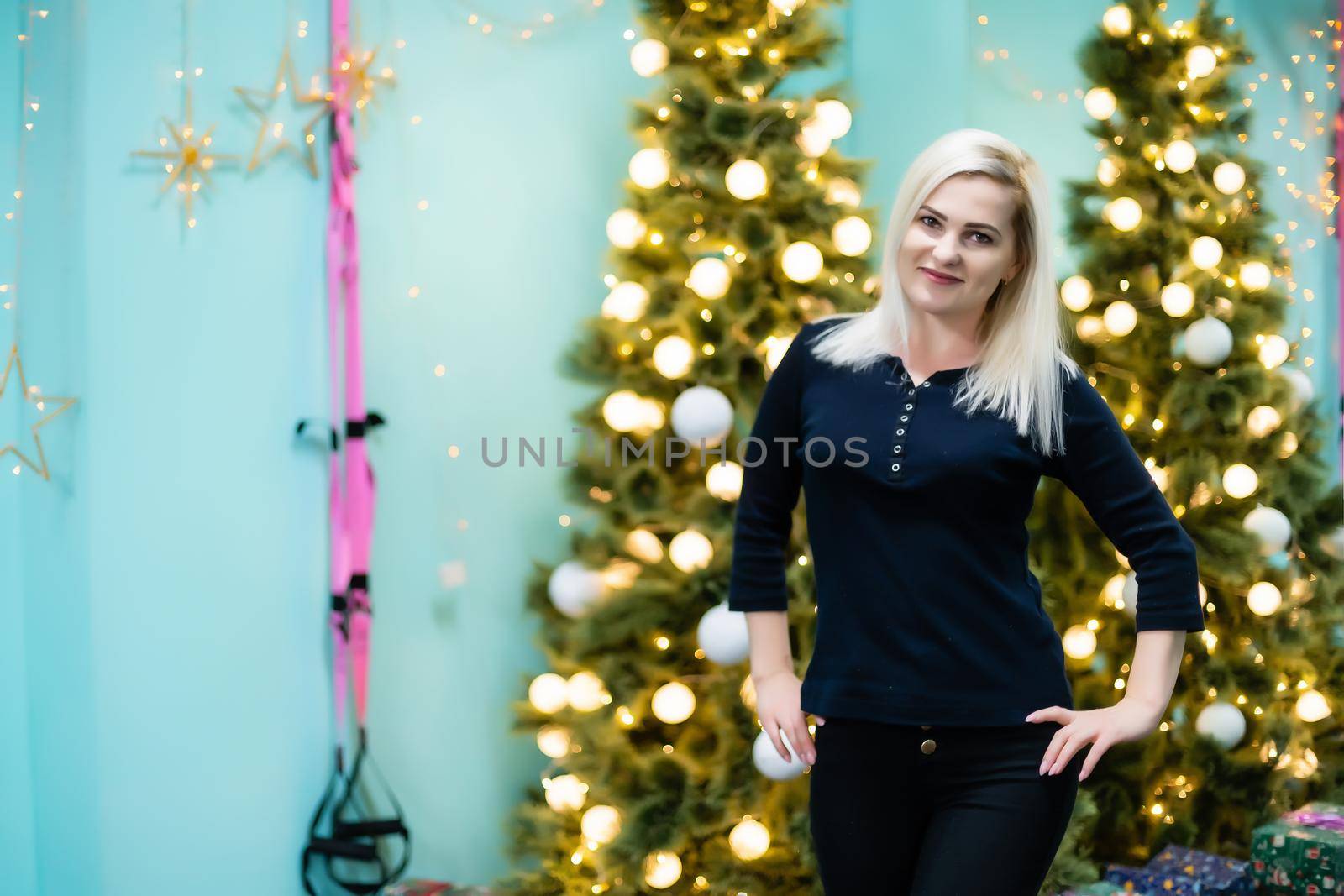woman near christmas tree in gym