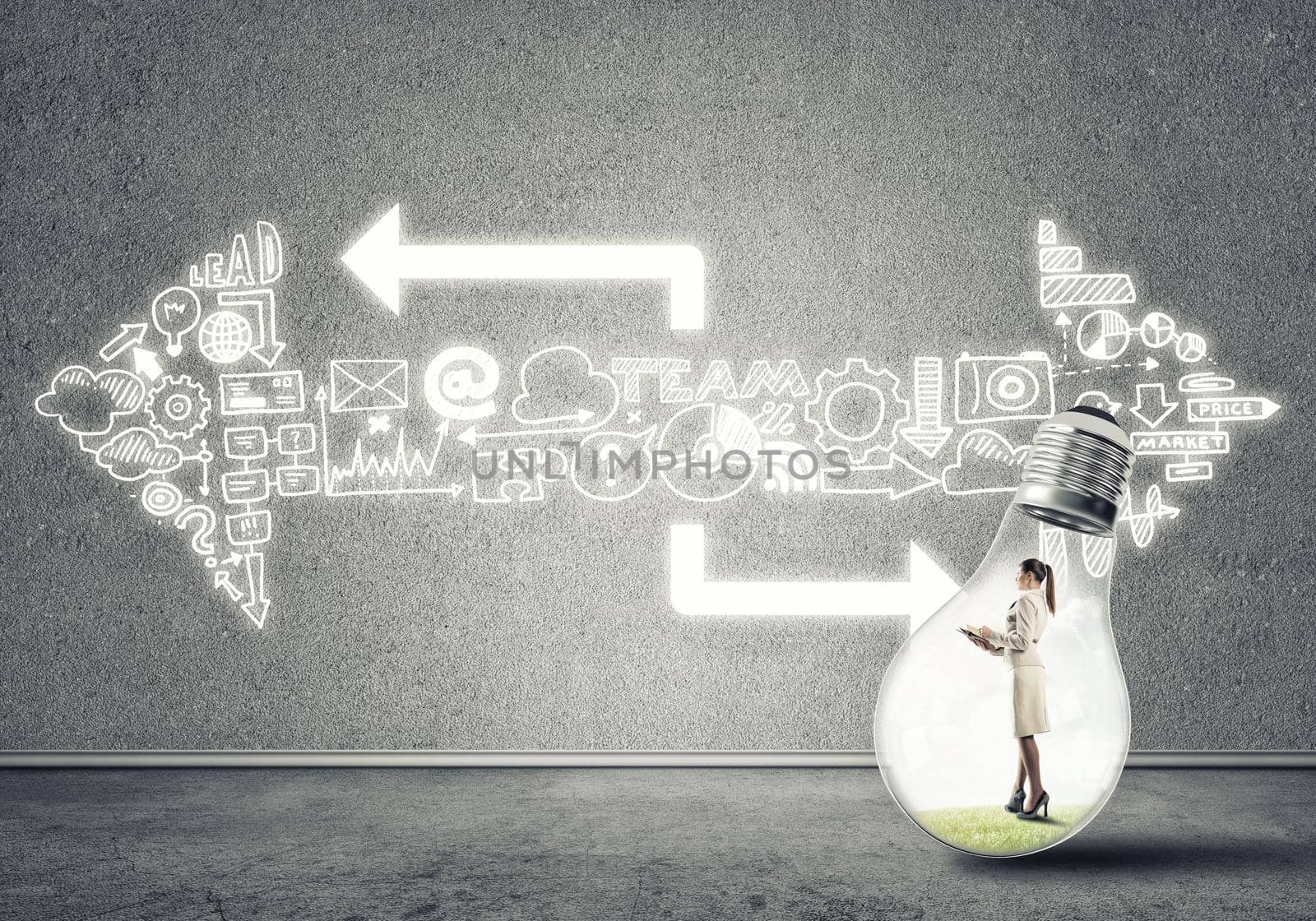 Businesswoman inside of light bulb in empty concrete room