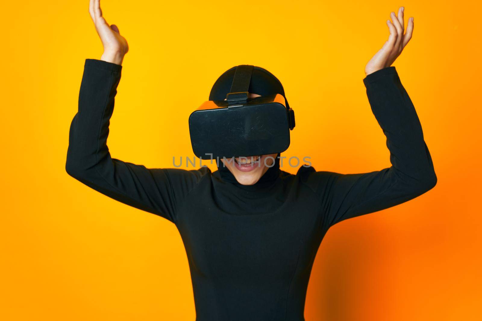 Muslim in black hijab VR glasses emotions studio lifestyle. High quality photo