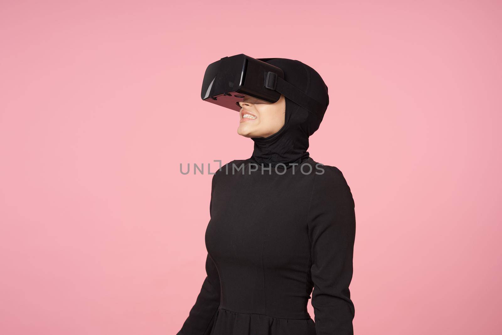 woman in black hijab glasses virtual reality technology movie watching. High quality photo