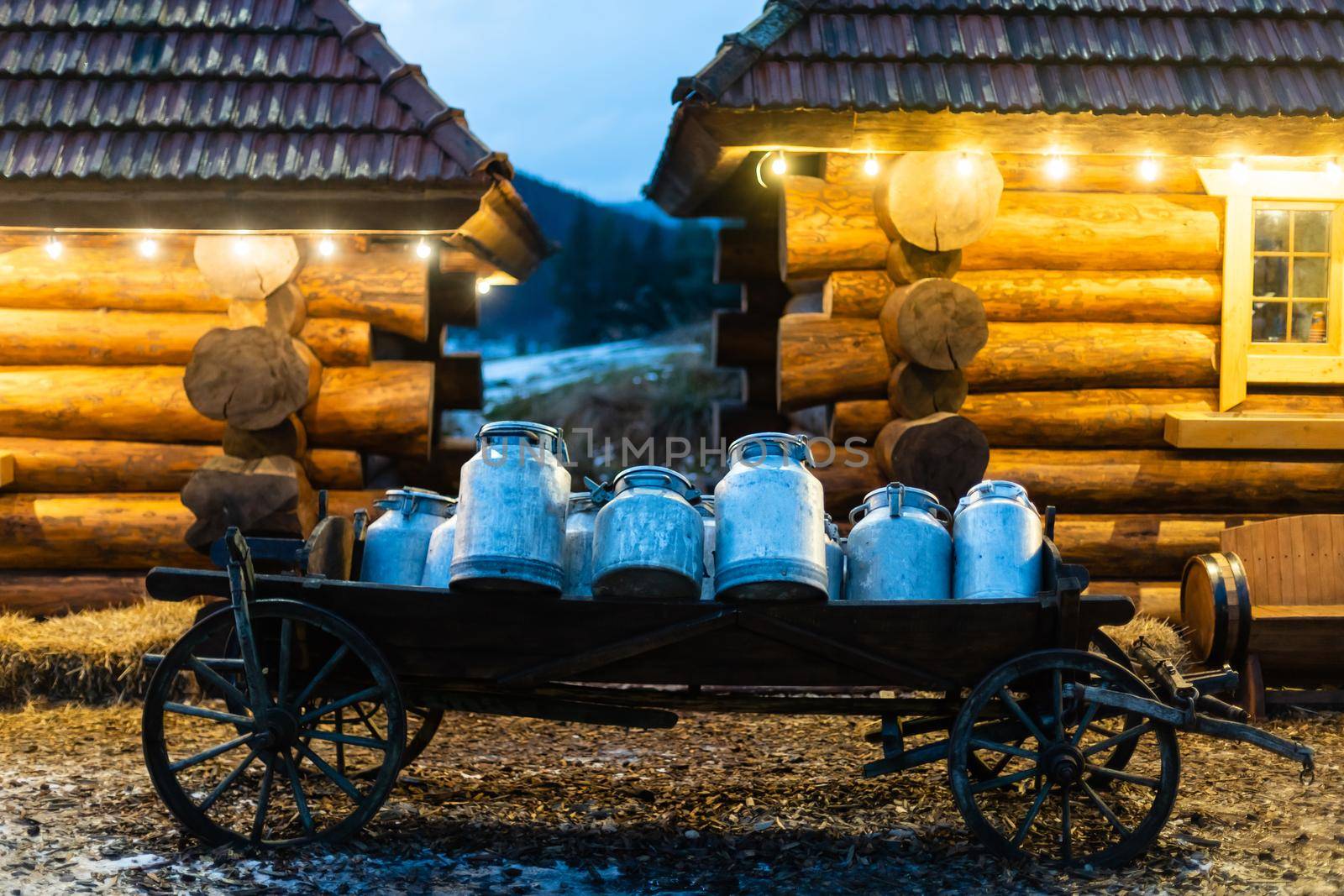 Vintage milk churns on railway platform.
