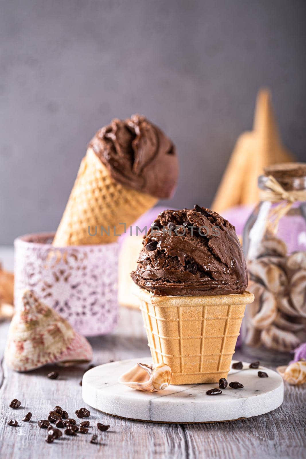 Delicious summer dessert chocolate ice cream in waffle cone. Summer healthy food concept, lactose free. Copy space.