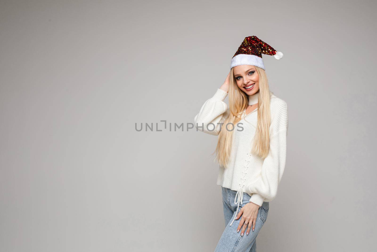 beautiful young woman with blonde hair poses on camera, picture isolated on white backgroung by StudioLucky