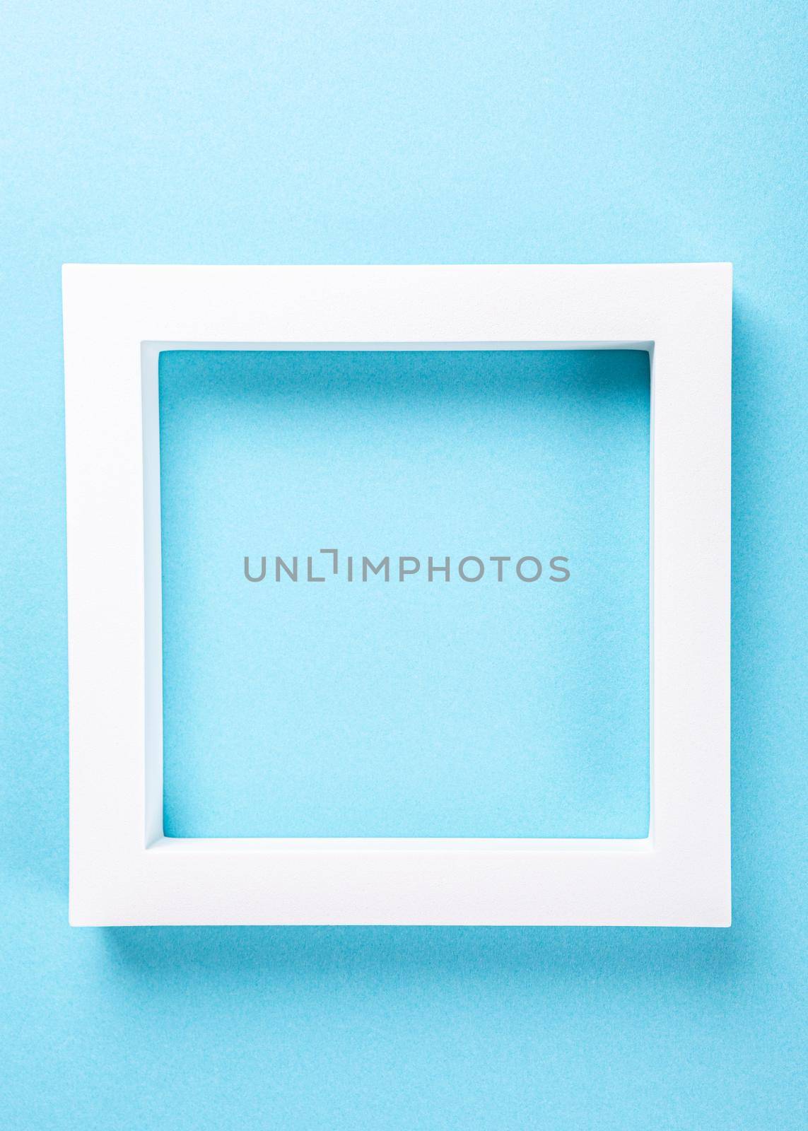 White foam frame on pastel blue background design. Minimal border composition with copy space. Moke up for presentation