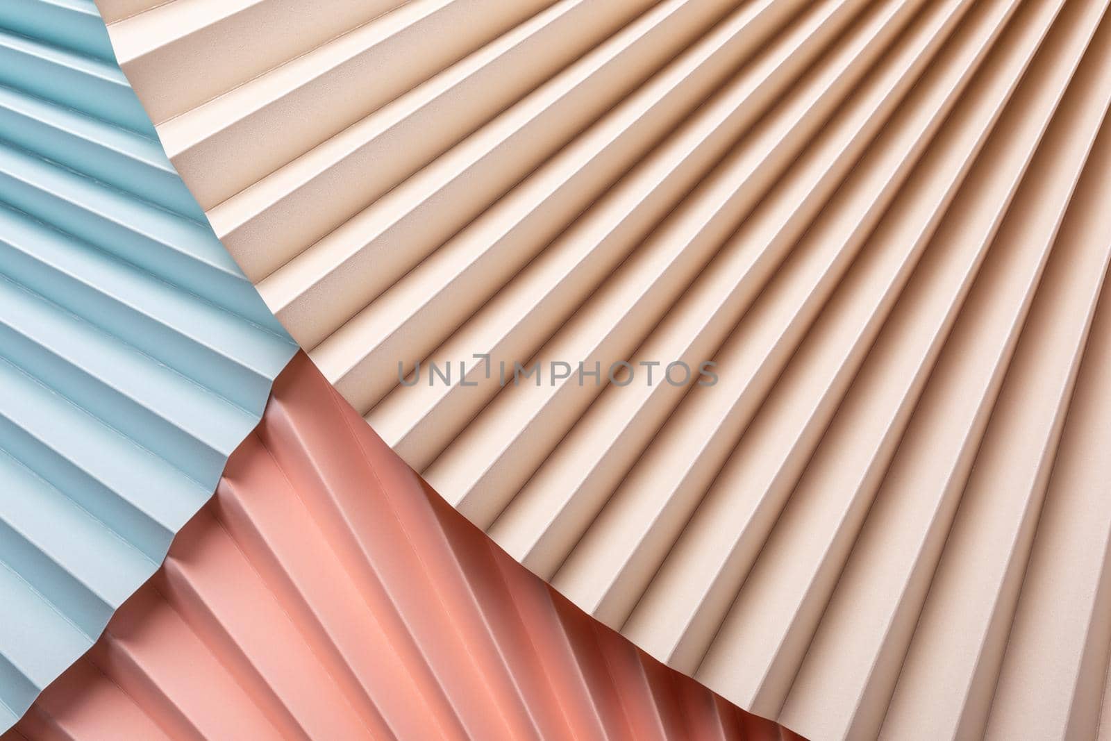 Colorful abstract background with paper fans, multicolored, light blue, pink and beige. Trend Concept. Top view, close up.