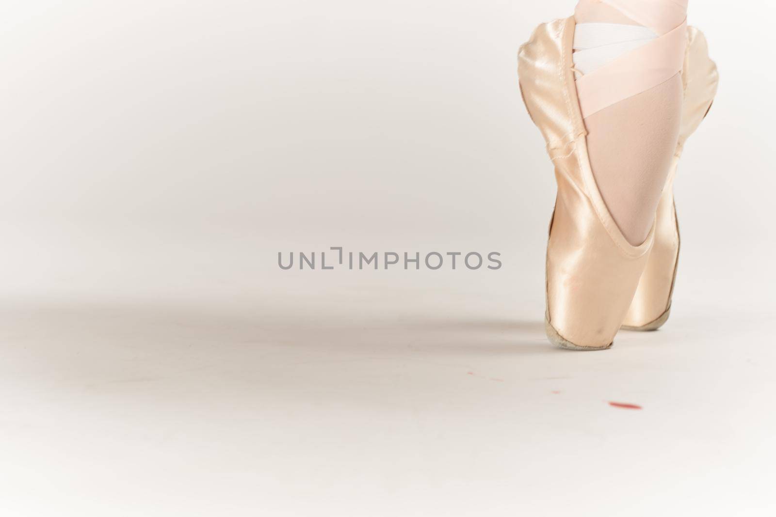 ballerina feet dance performed classical style light background. High quality photo