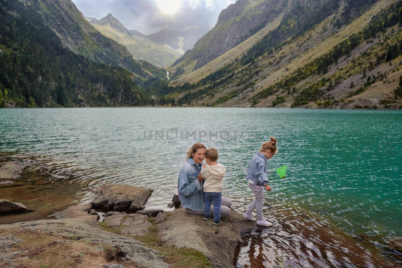 Family near a french lake Gaube at the high pyrenees