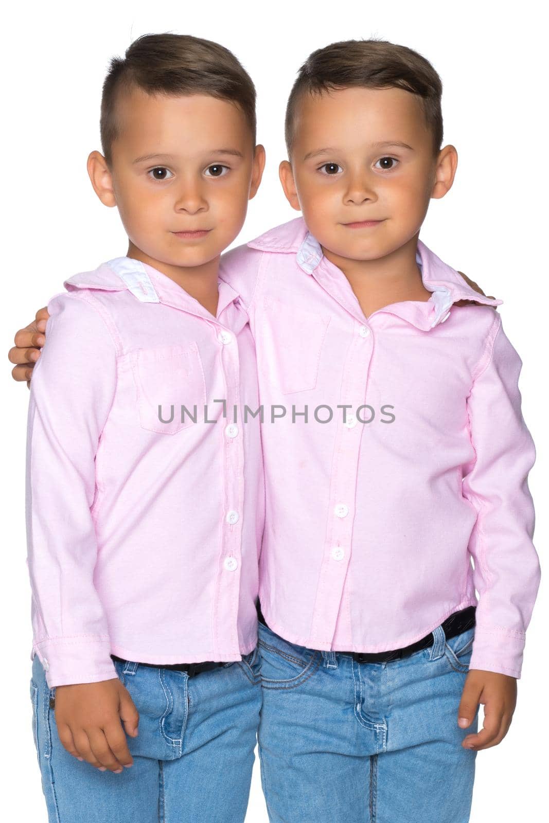 Two cute little boys, brothers close-up. The concept of a happy childhood, the development of a child in the family. Isolated on white background.