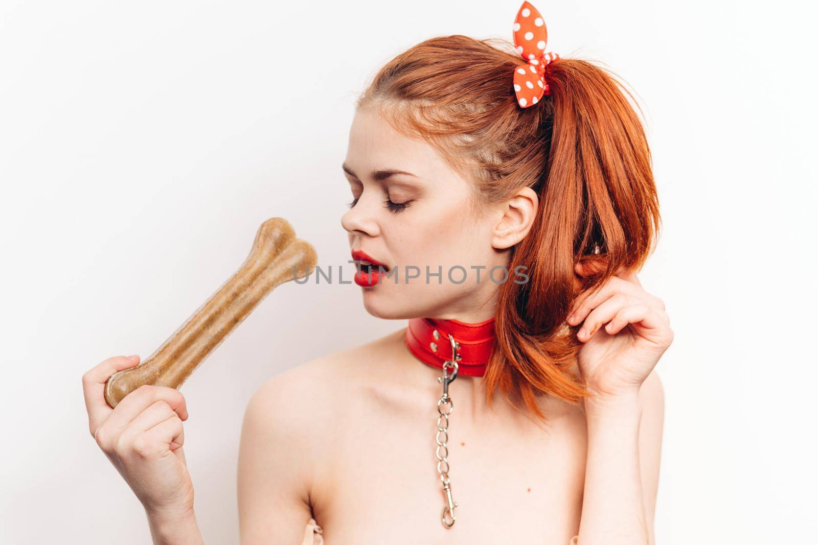 pretty woman with leash around her neck dog bone costume posing by Vichizh