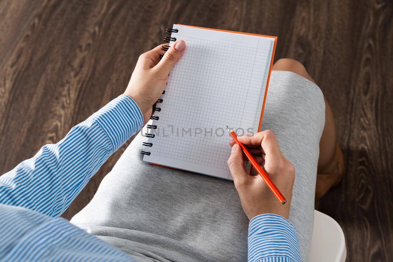 close-up a female hands with notebook and pencil