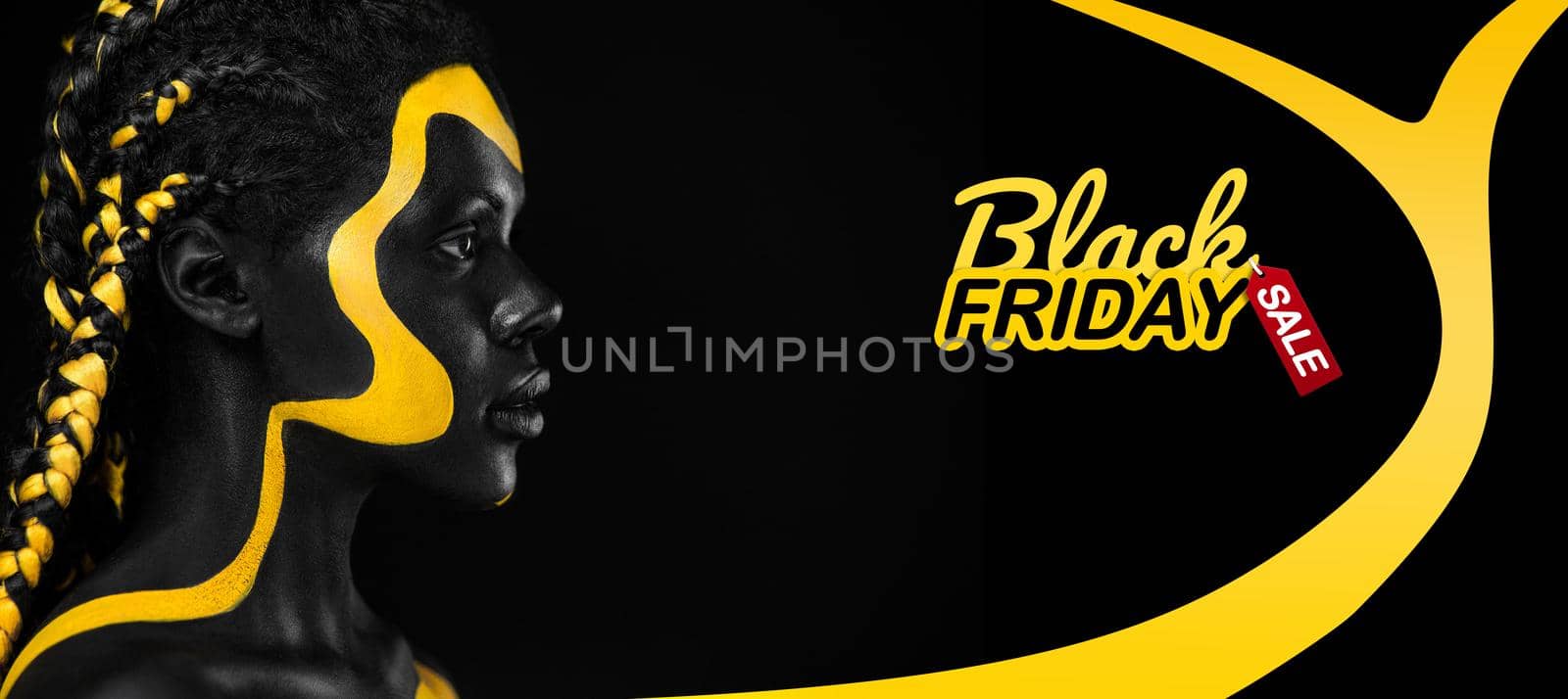 Black friday sale and shopping concept Woman with body paint. Cheerful young african girl with art bodypaint. An amazing model with yellow and black makeup. by MikeOrlov