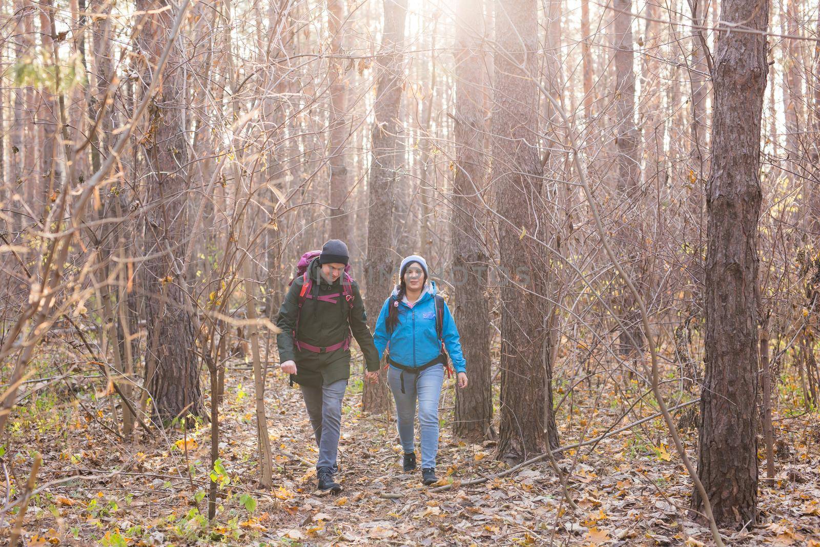 People, hike, tourism and nature concept - Couple tourist hiking in autumn forest by Satura86