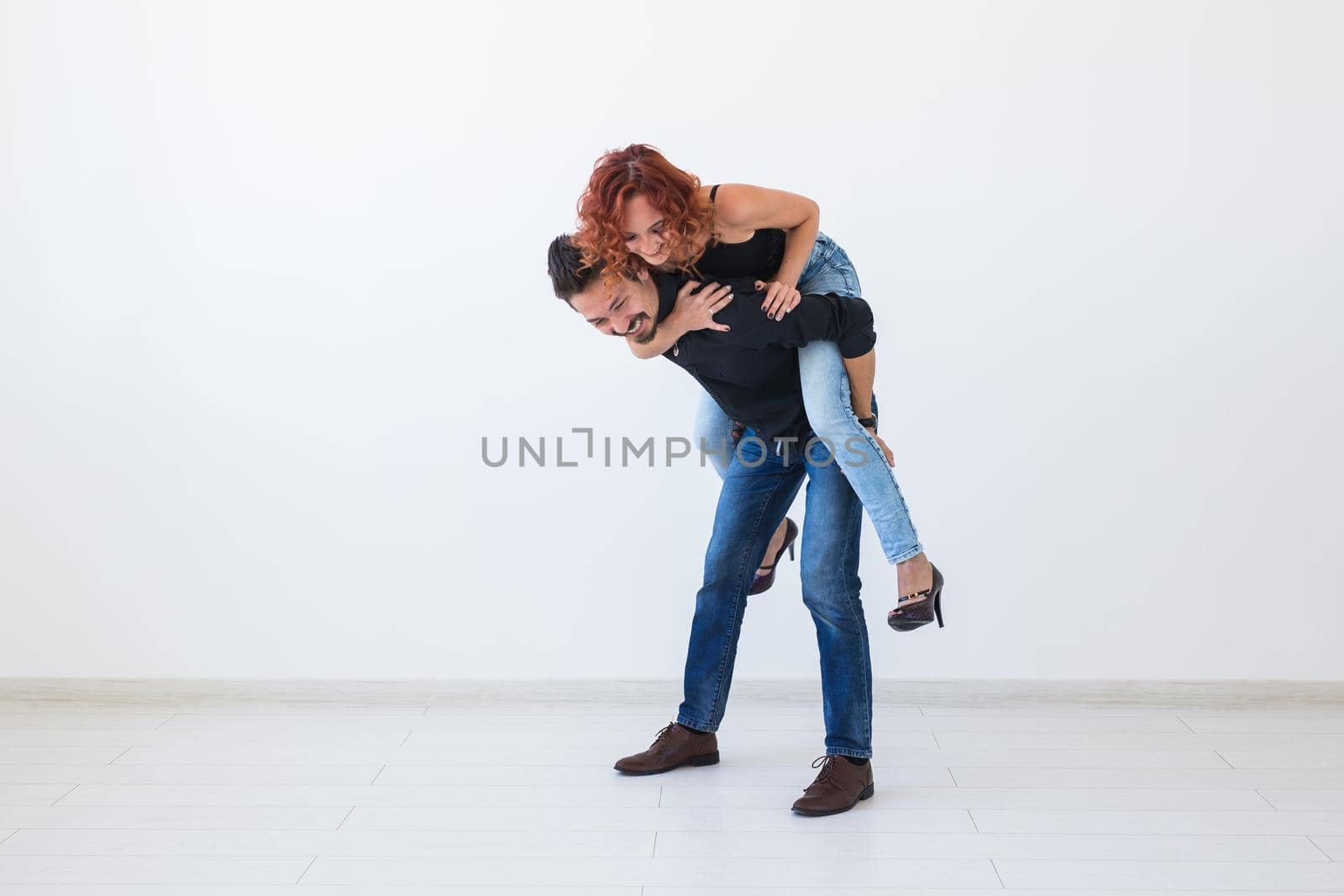 Friendship, people concept - young woman jumped on the man's back by Satura86