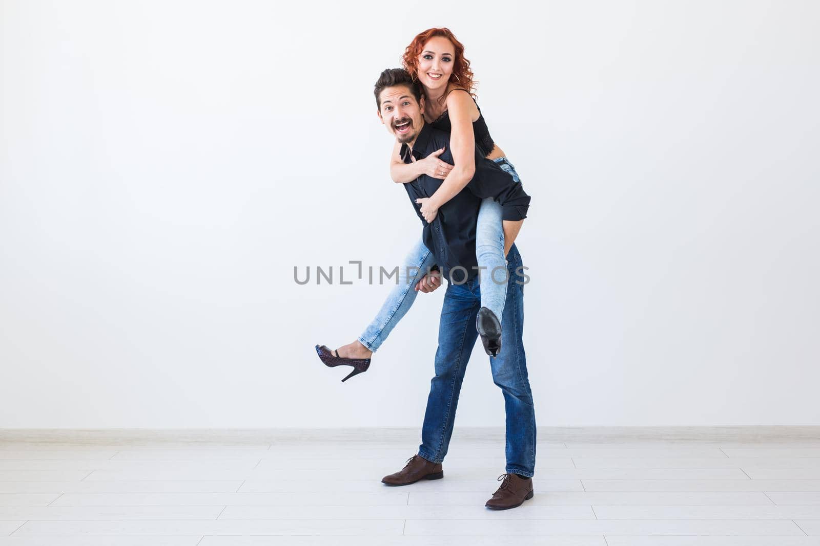 Friendship, people concept - young woman jumped on the man's back by Satura86