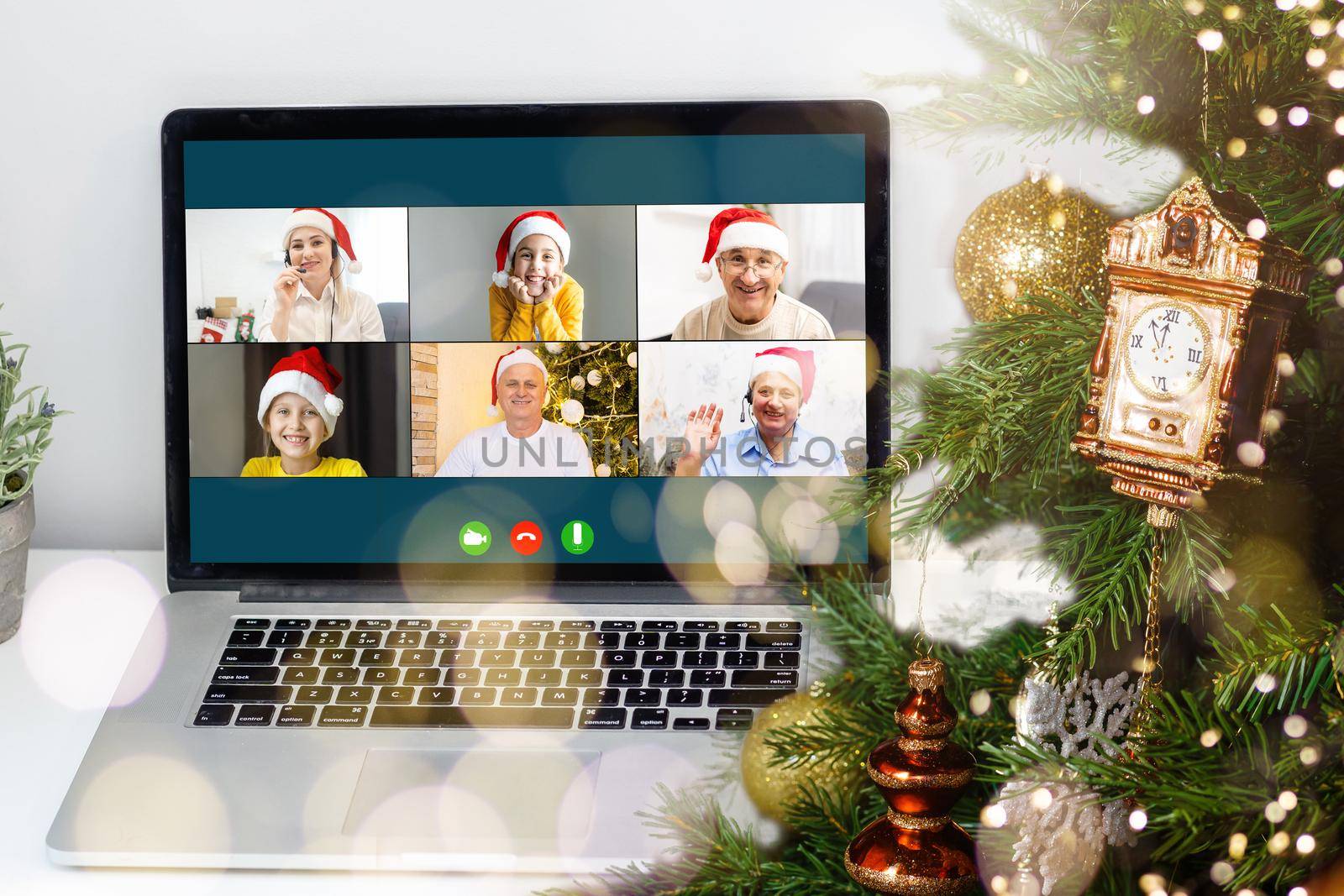video call with happy diverse children on laptop computer in his workshop. Self-isolation and virtual online celebration at home concept. Christmas.