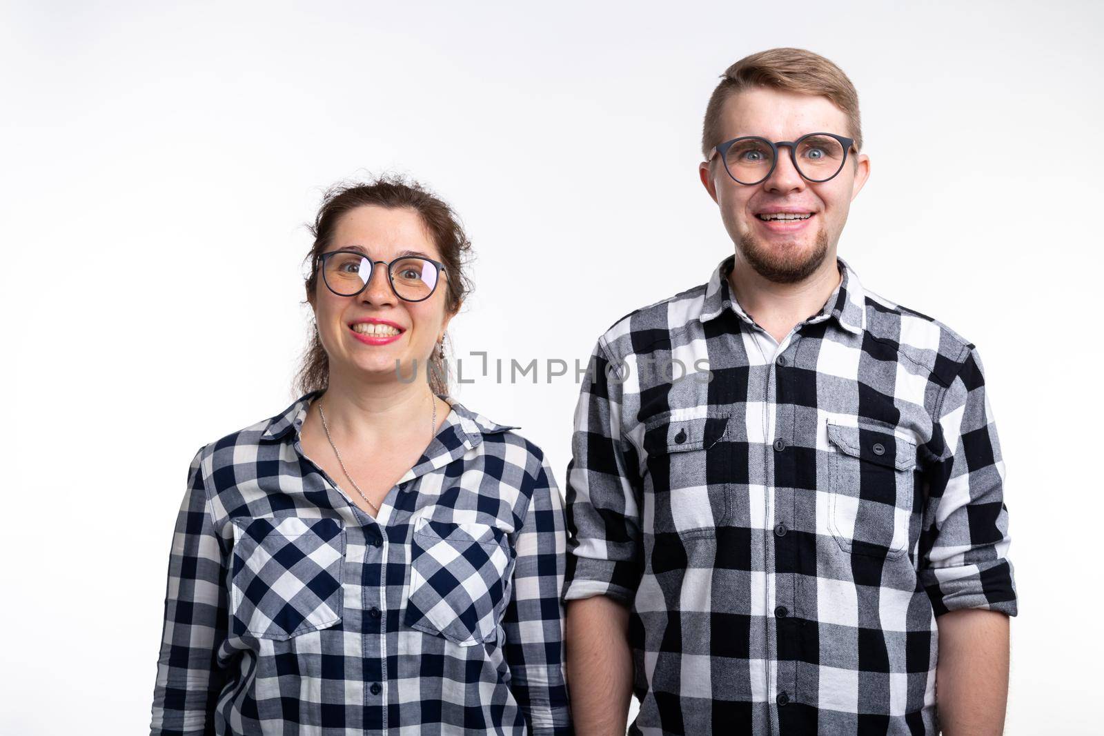 People and education concept - Two students with funny faces over white background.