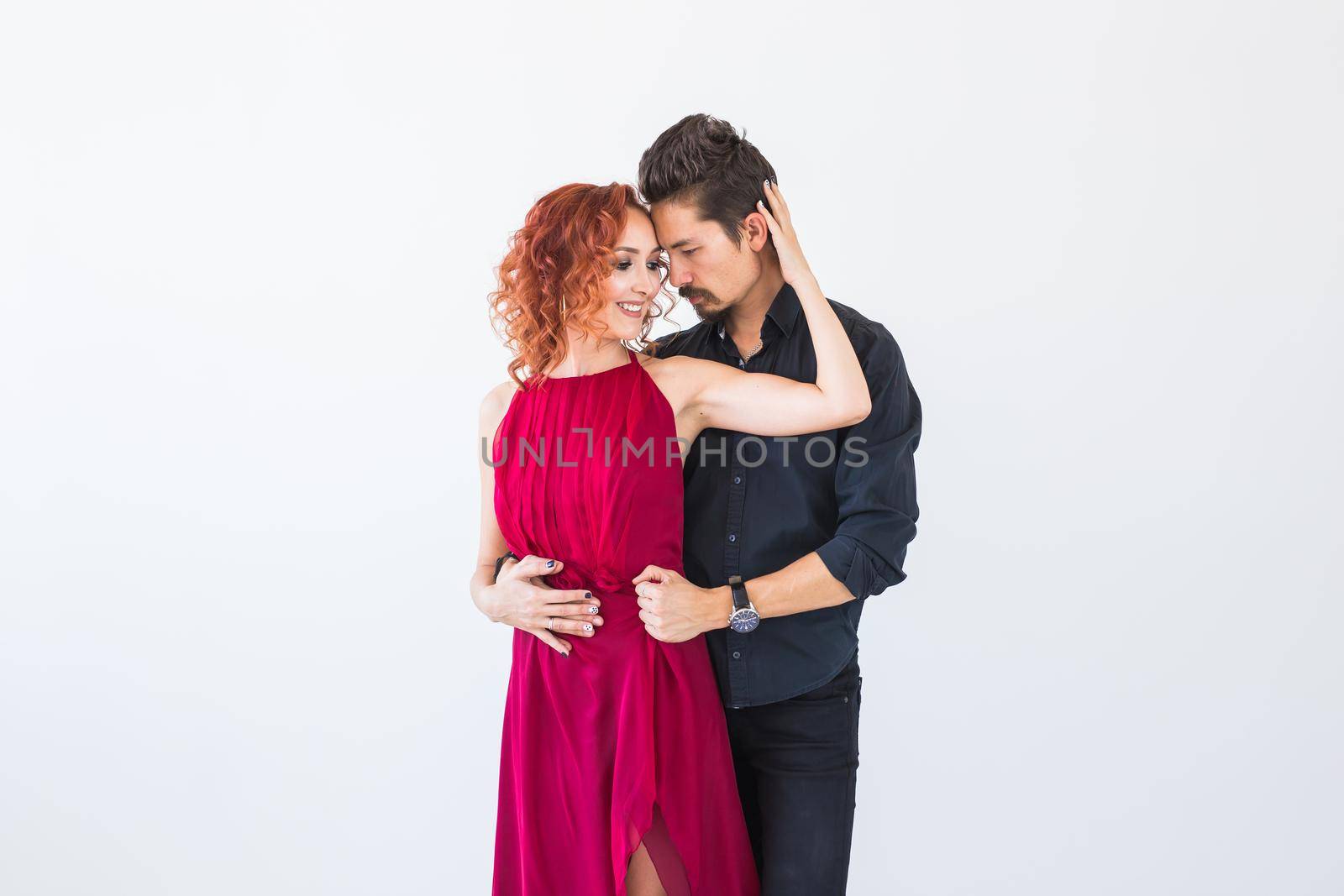 Social dance, bachata, kizomba, salsa, tango concept - Close up portrait of woman man dressed in beautiful outfits over white background.